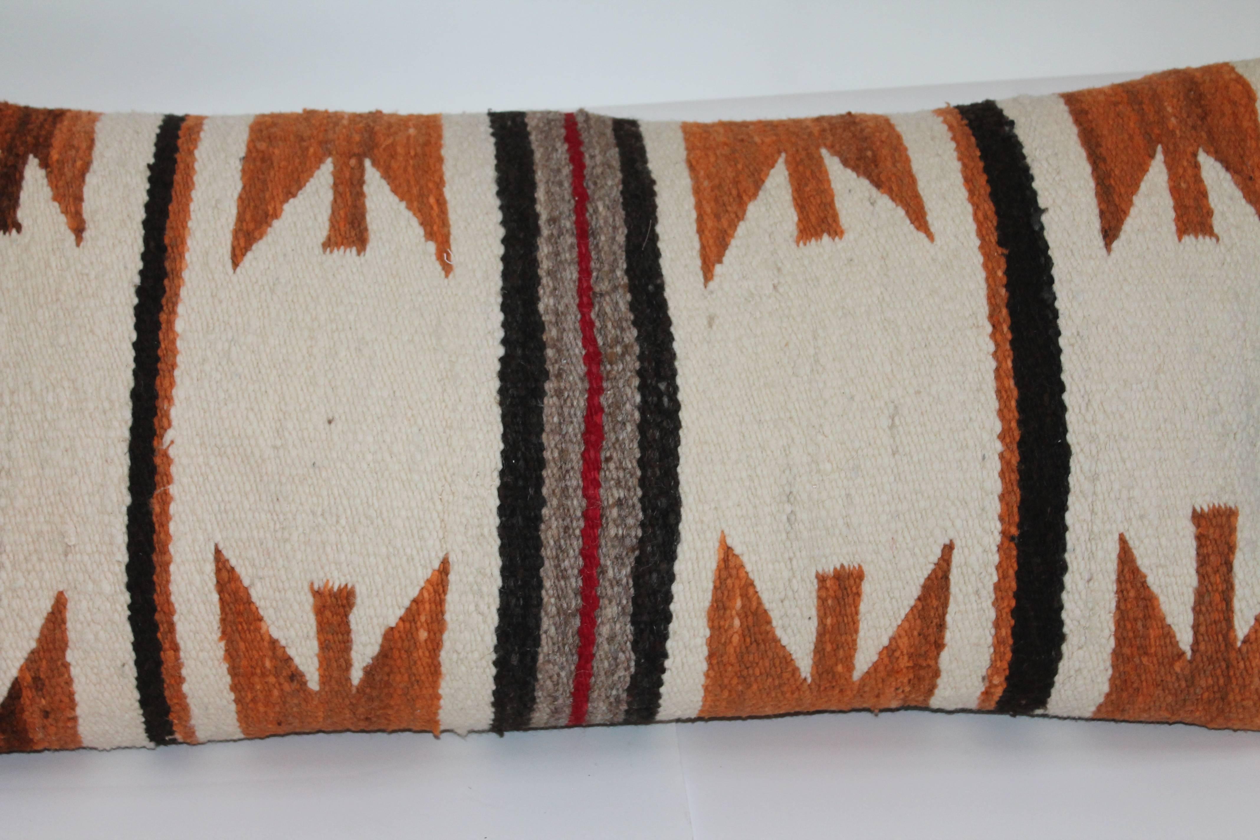 Early Navajo weaving bolster pillow with taupe cotton backing. The geometric cheddar pattern is most unusual.