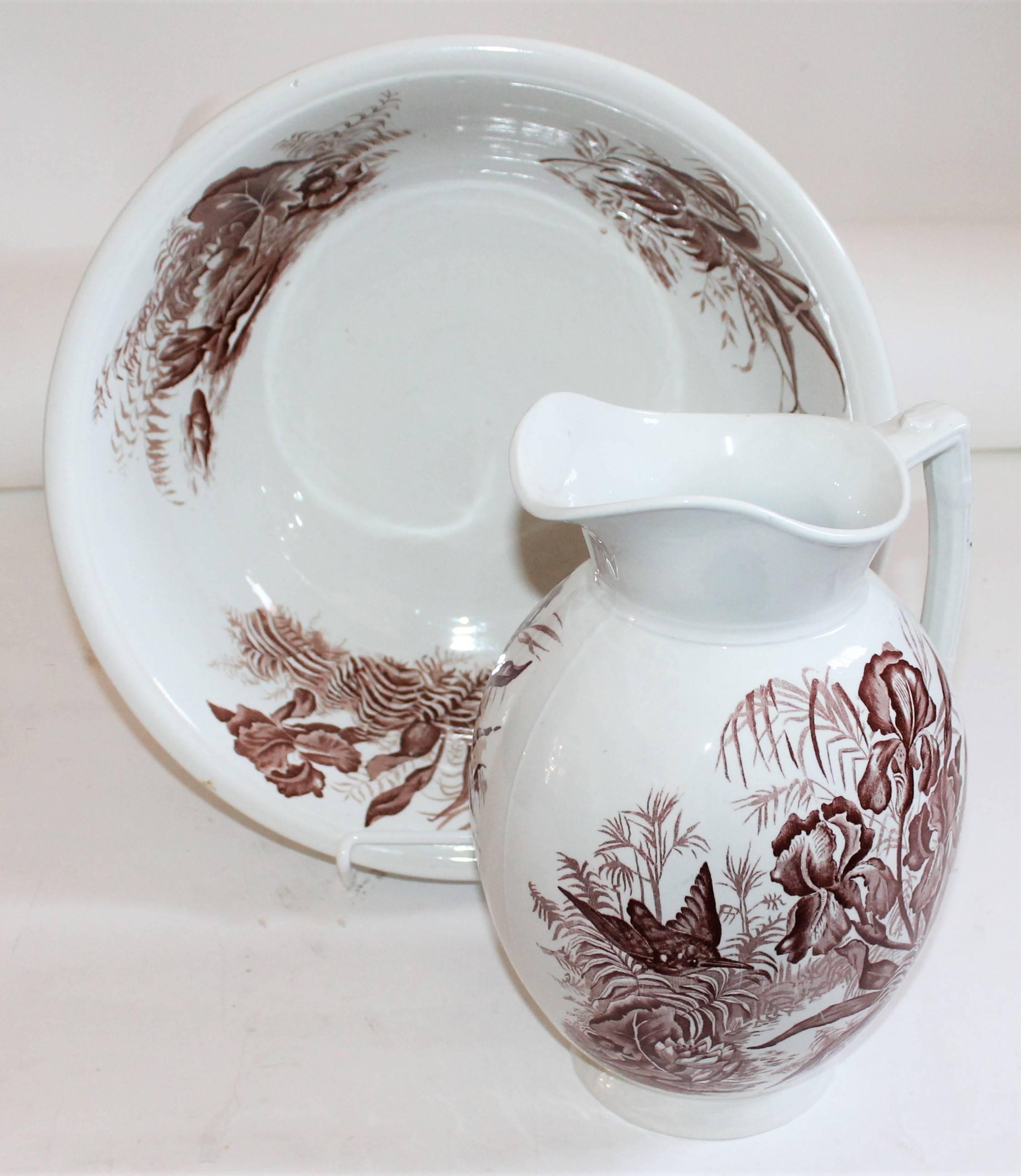 This mellow country floral brown and white transfer ware ironstone pitcher and bowl matching set. Signed F, W, & Company / England. The condition is very good.