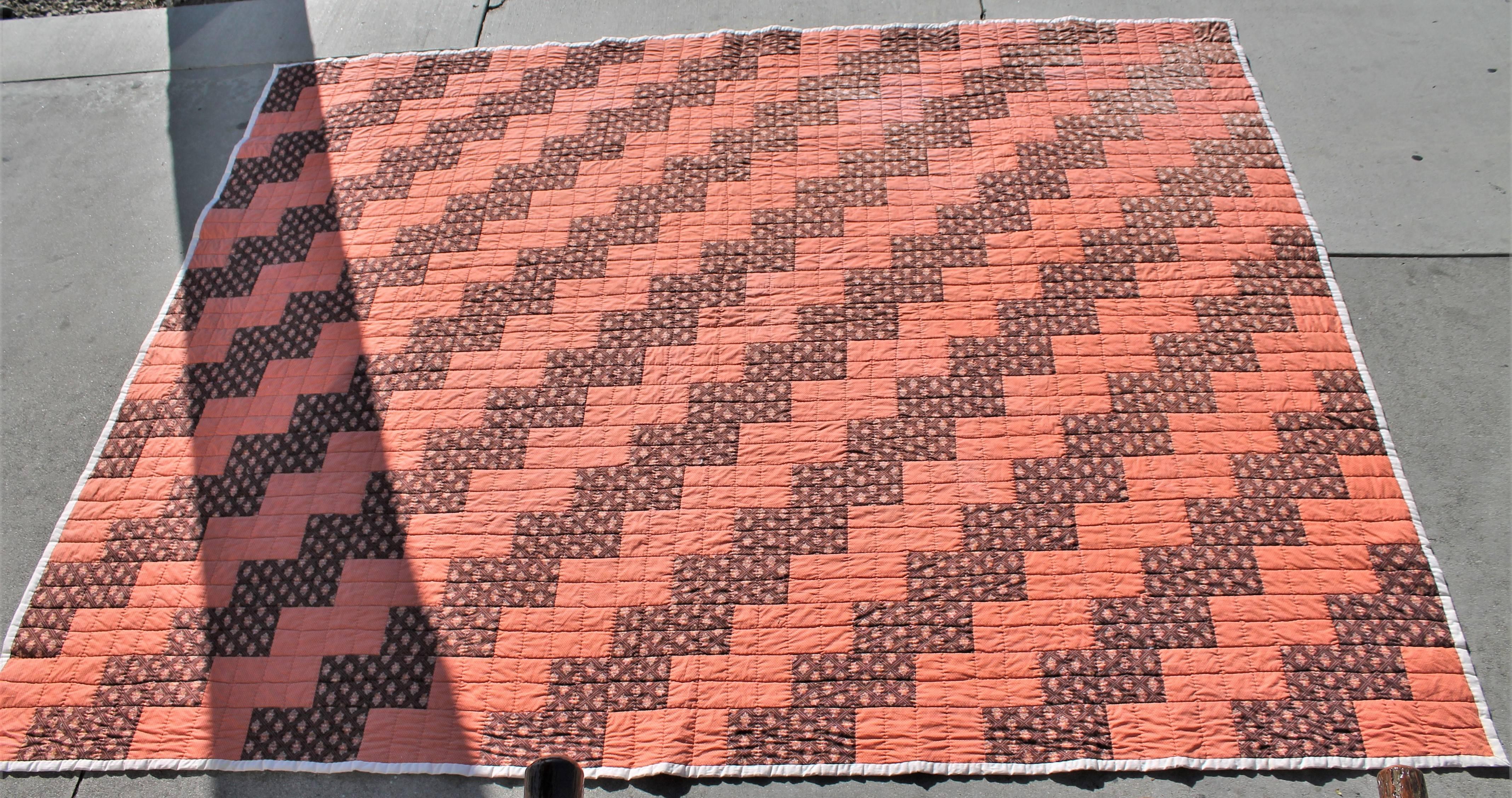 This streak of lighting quilt is in brown calico fabric. This condition is very good.