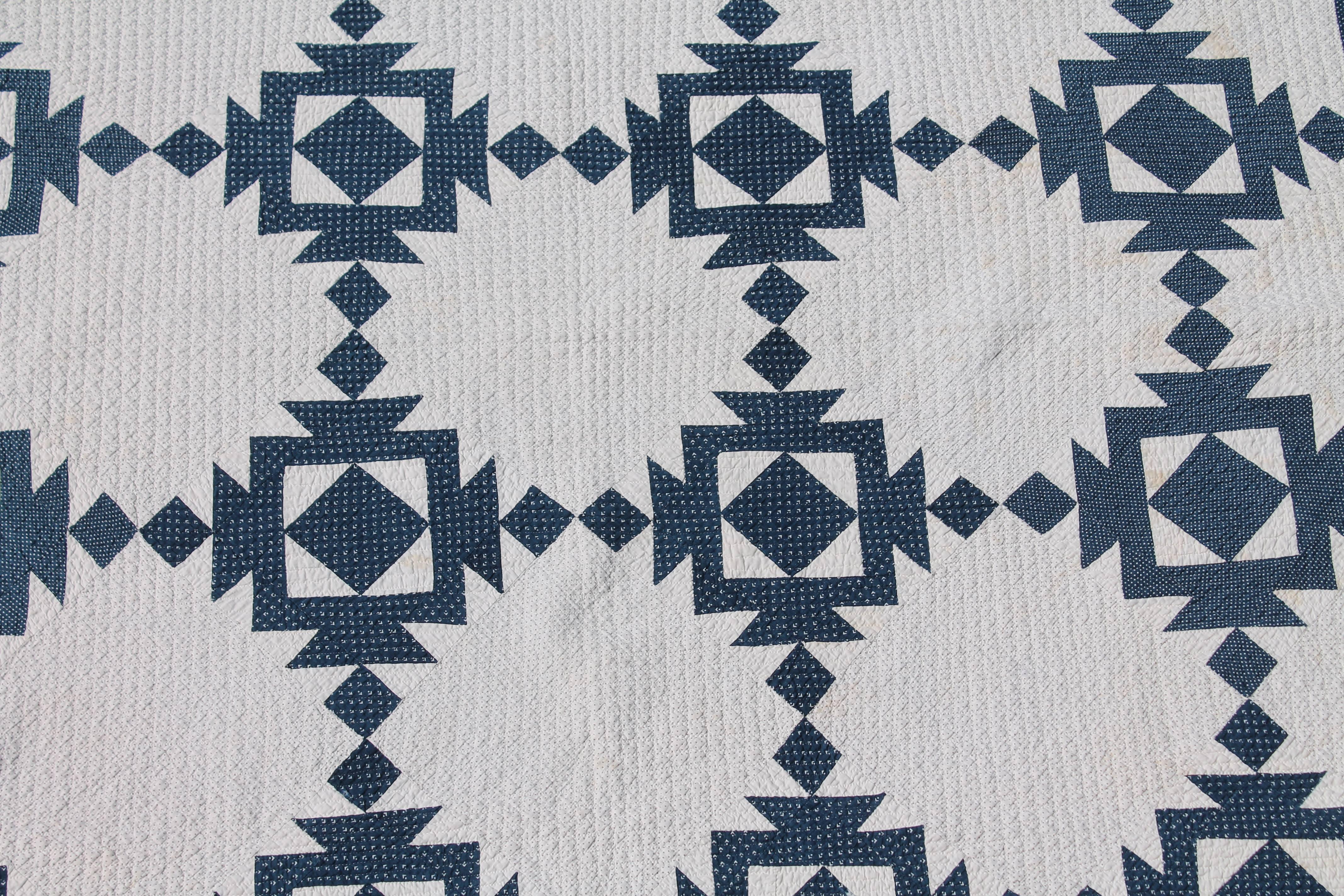 This finely quilted blue and white geometric quilt was found in Pennsylvania and is in very good condition. There is minor age spots the size of a pin head but no tears or damages.