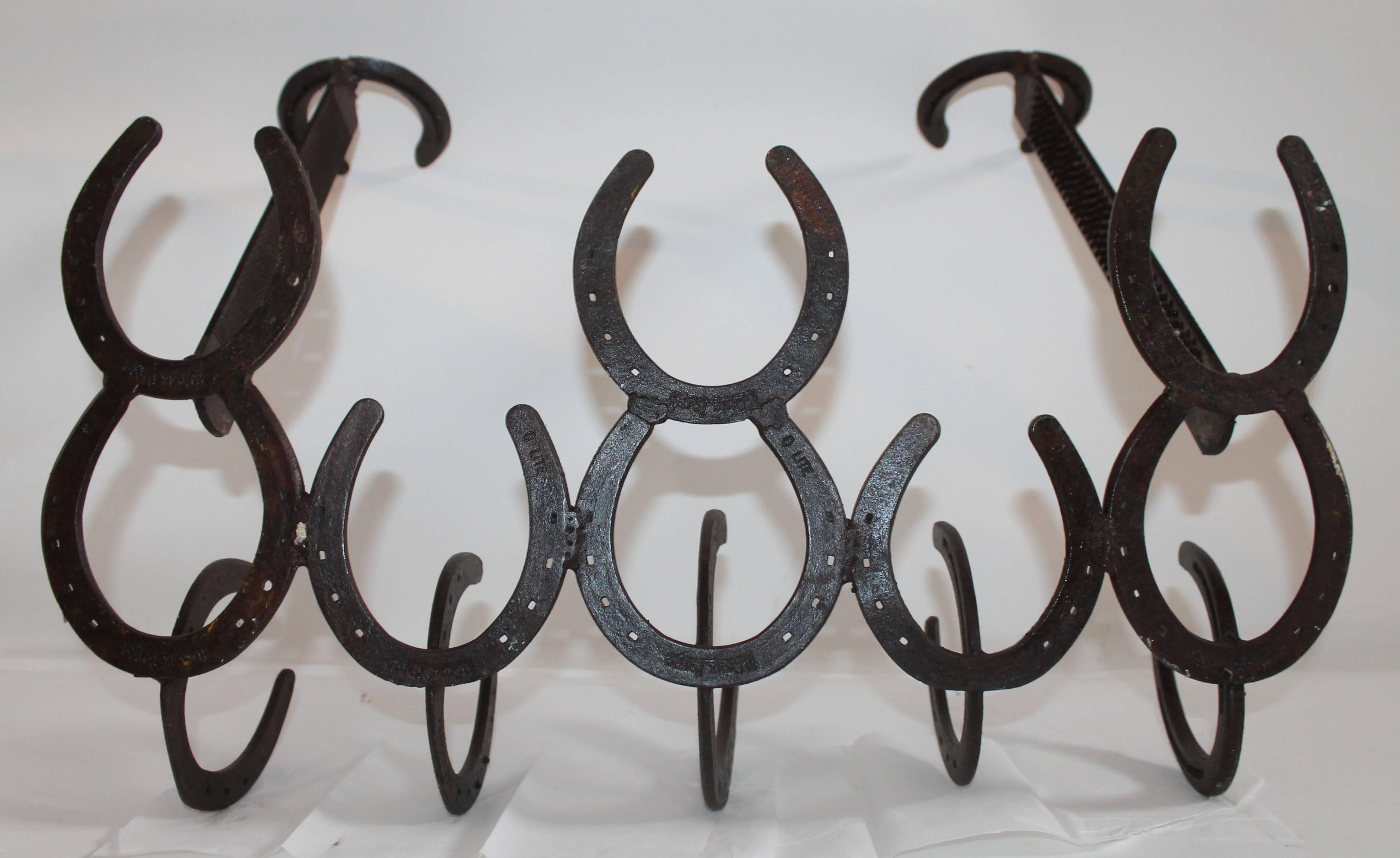 This handmade iron horse shoe Folk Art hat and coat rack is in good condition. It has a great rustic and western appeal.