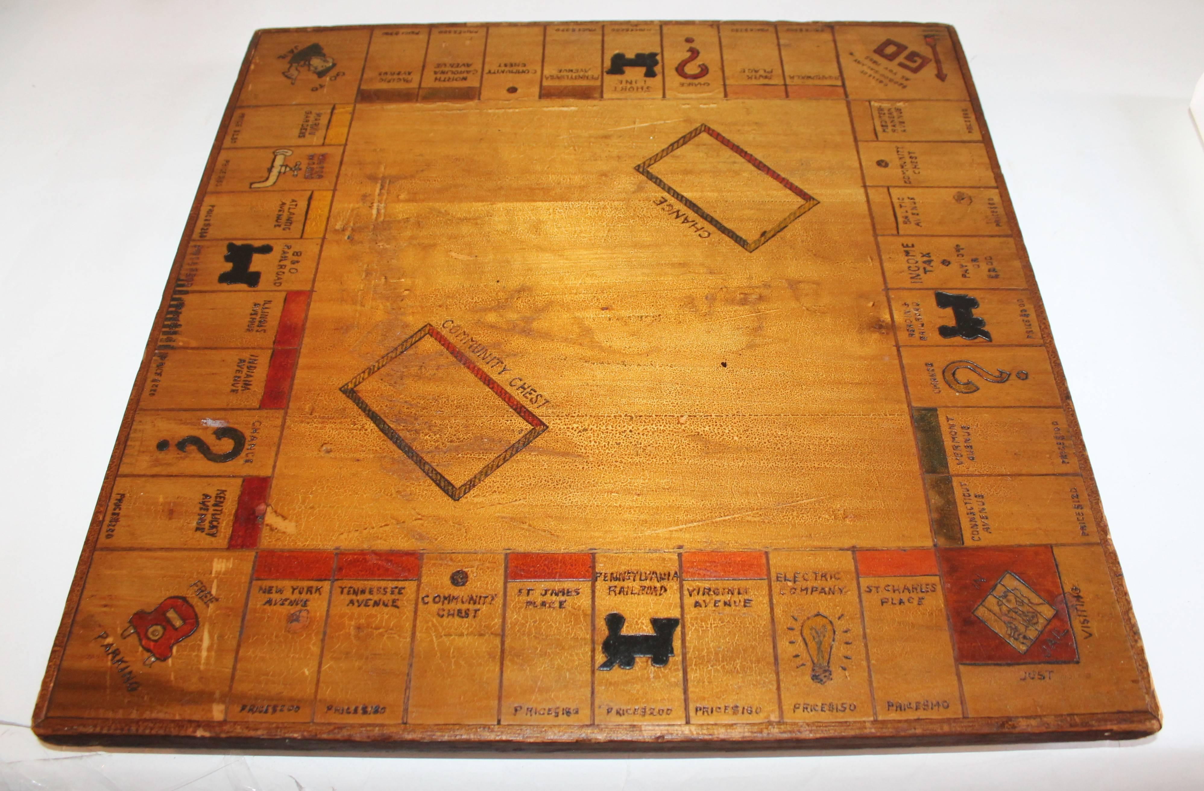 This handmade one of a kind folky 1930s monopoly hand-carved and painted wood game board is in as found condition. The backing edge lip is covered in a wool felt, see photos. The felt is worn consistent with age and use.