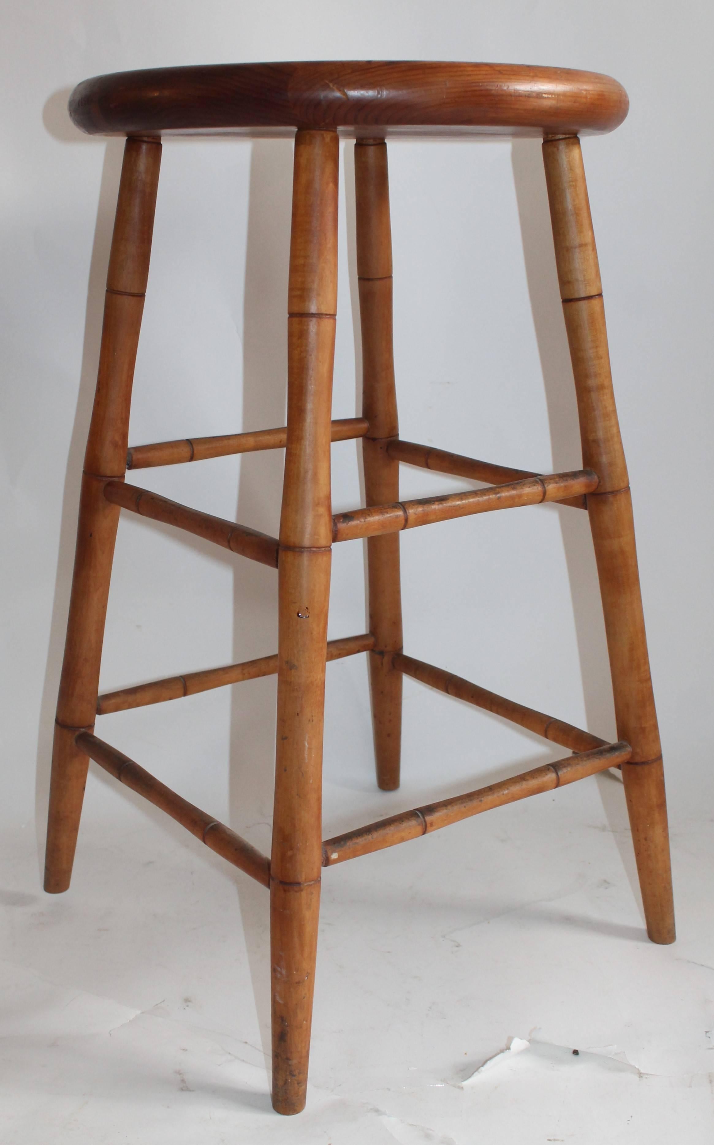 The condition and patina is the very best. The patina is the very best. This simple bar stool has a nice country look. The diameter of the plank seat is 18inches 
The furthest corner legs are 22inches apart. The height is 28