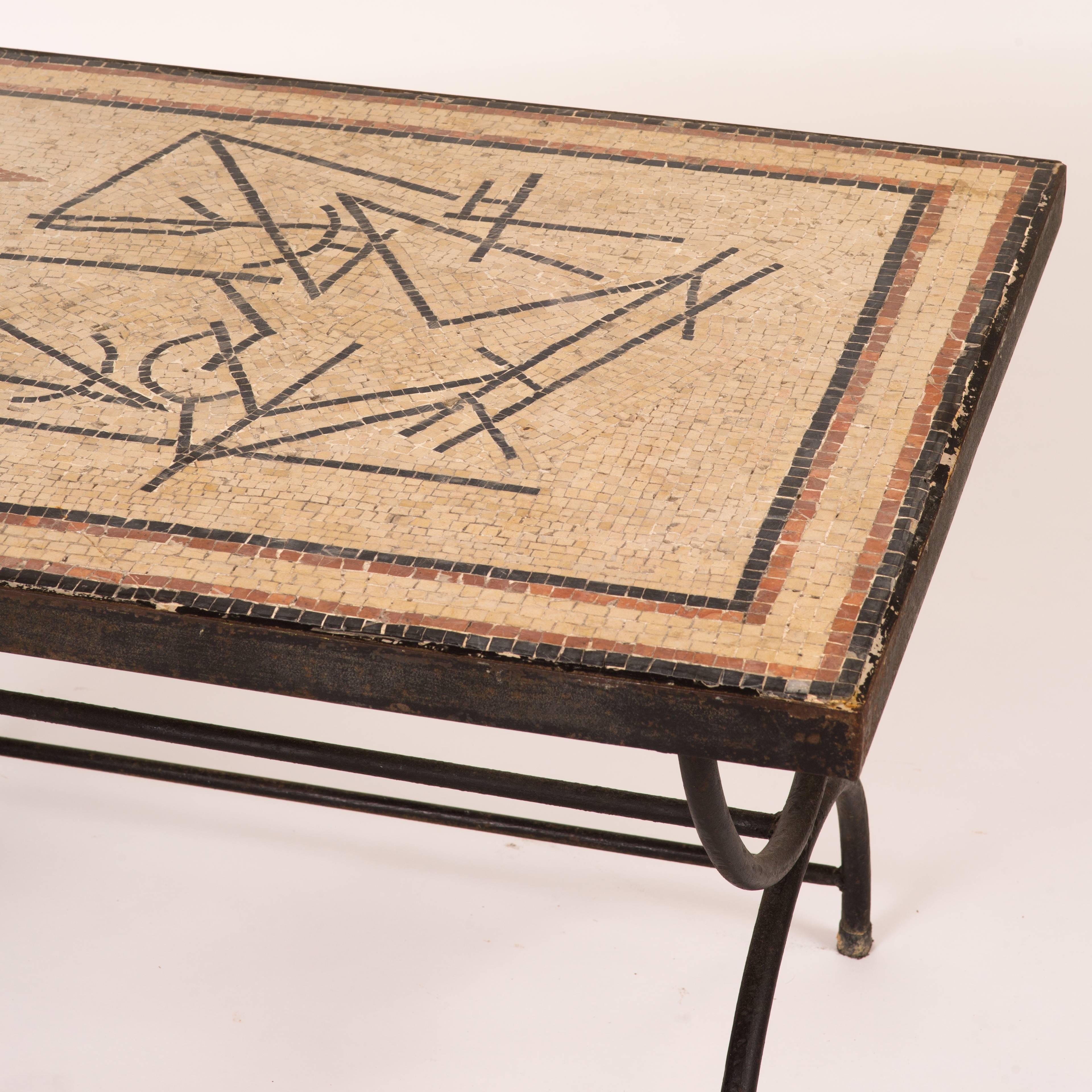 An iron coffee table with mosaic top.