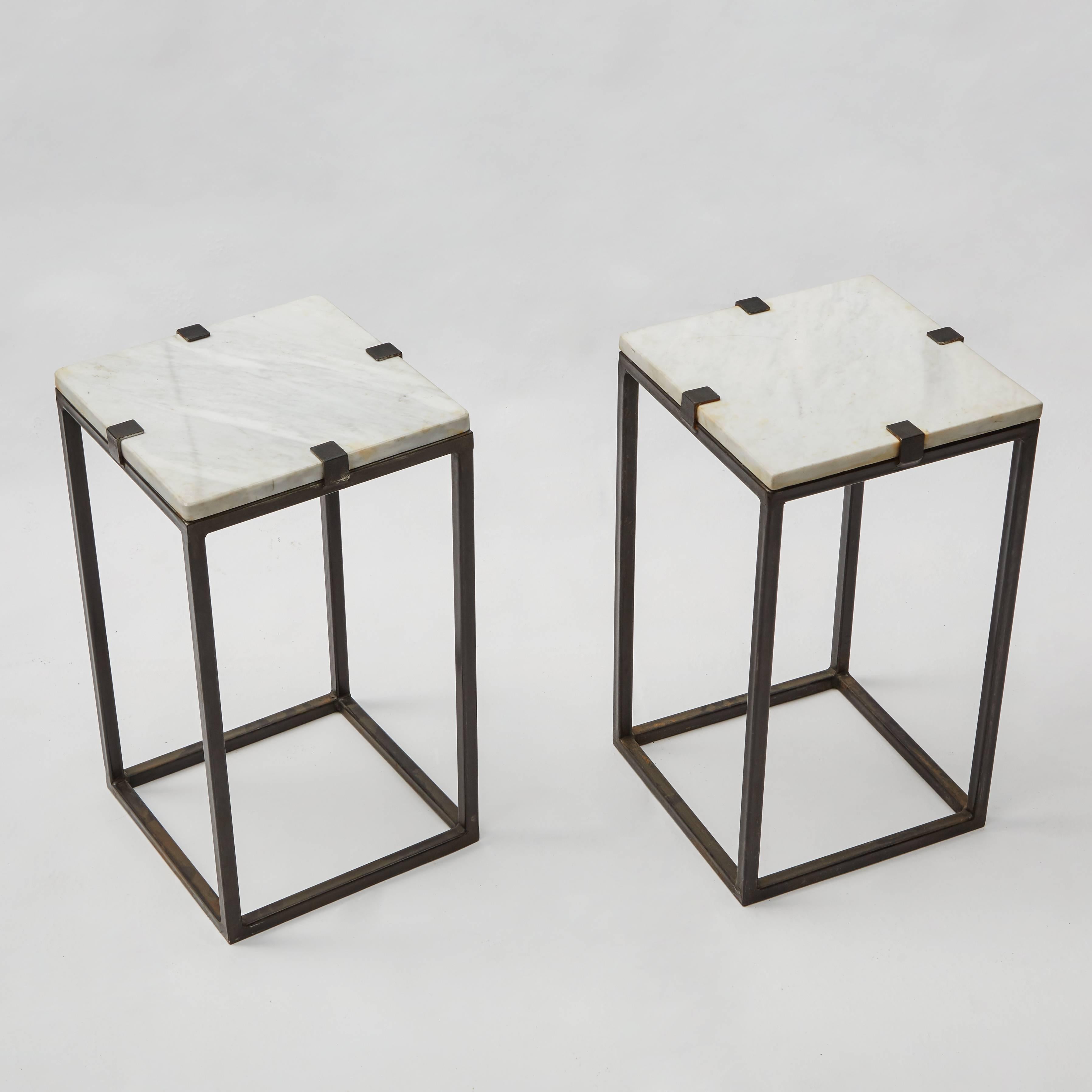 A pair of Industrial side table with simple modern metal base and marble tops.