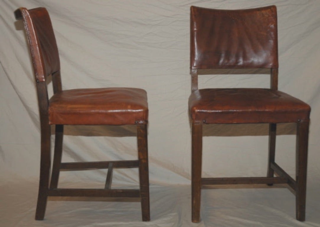 Set of six oak dining chairs with original auburn leather upholstery from early 20th-century France. Simple yet comfortable, the set adds a relaxed, rustic dimension to any dining arrangement. 

France, circa 1900

Dimensions: 18W x 19D X 33H.
