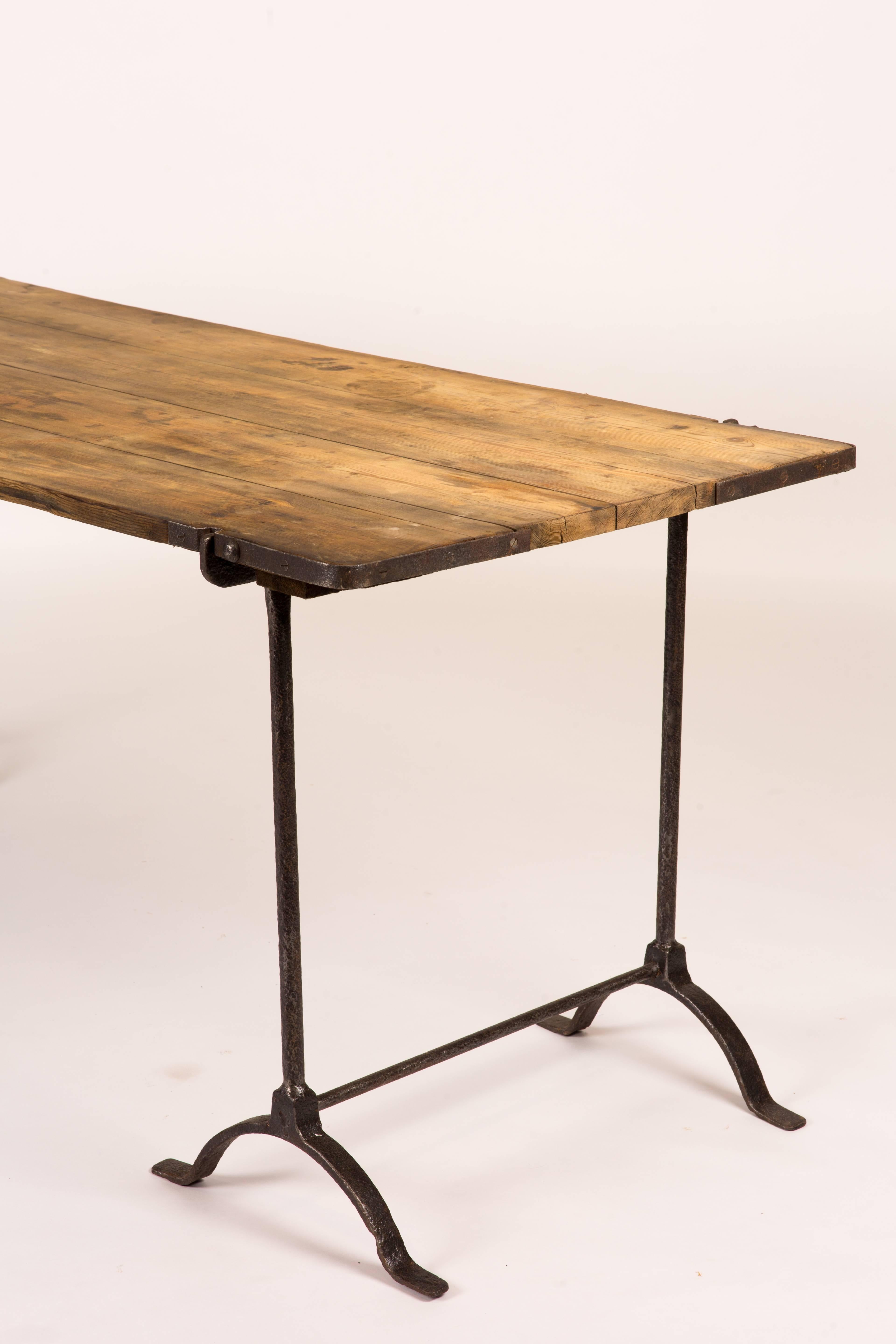 Trestle table with iron legs and oakwood top from England circa 1850. Can serve as a desk, or sideboard.