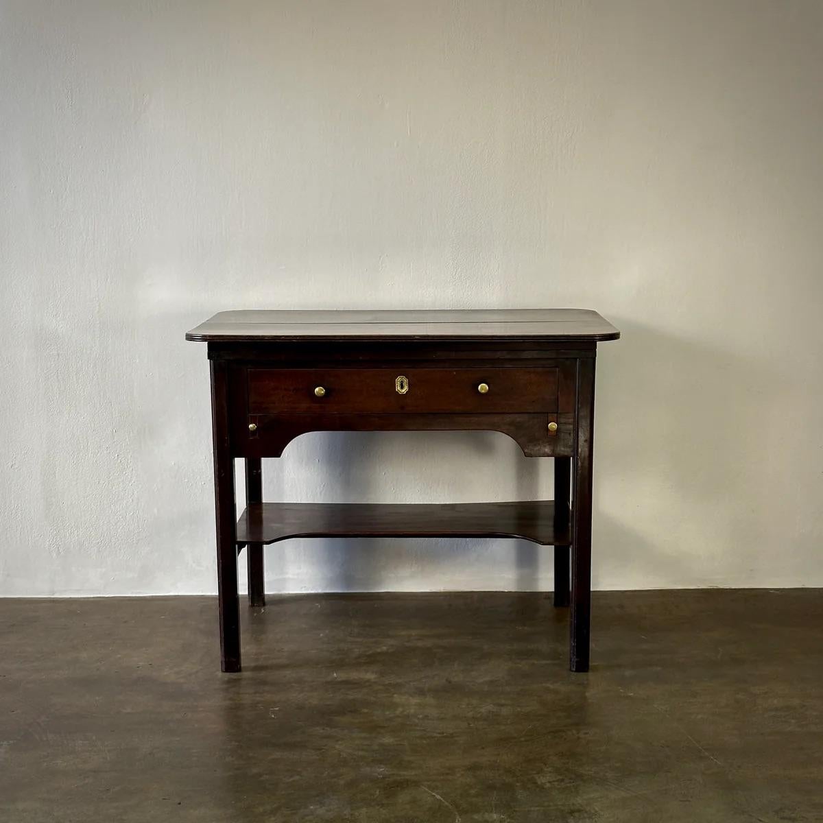 Georgian architect's table in richly stained oak with an adjustable slanting top and elegant brass hardware. Charmingly proportioned to serve as a console, end table, or desk.

England, circa 1820

Dimensions: 38W x 29.5D x 31H