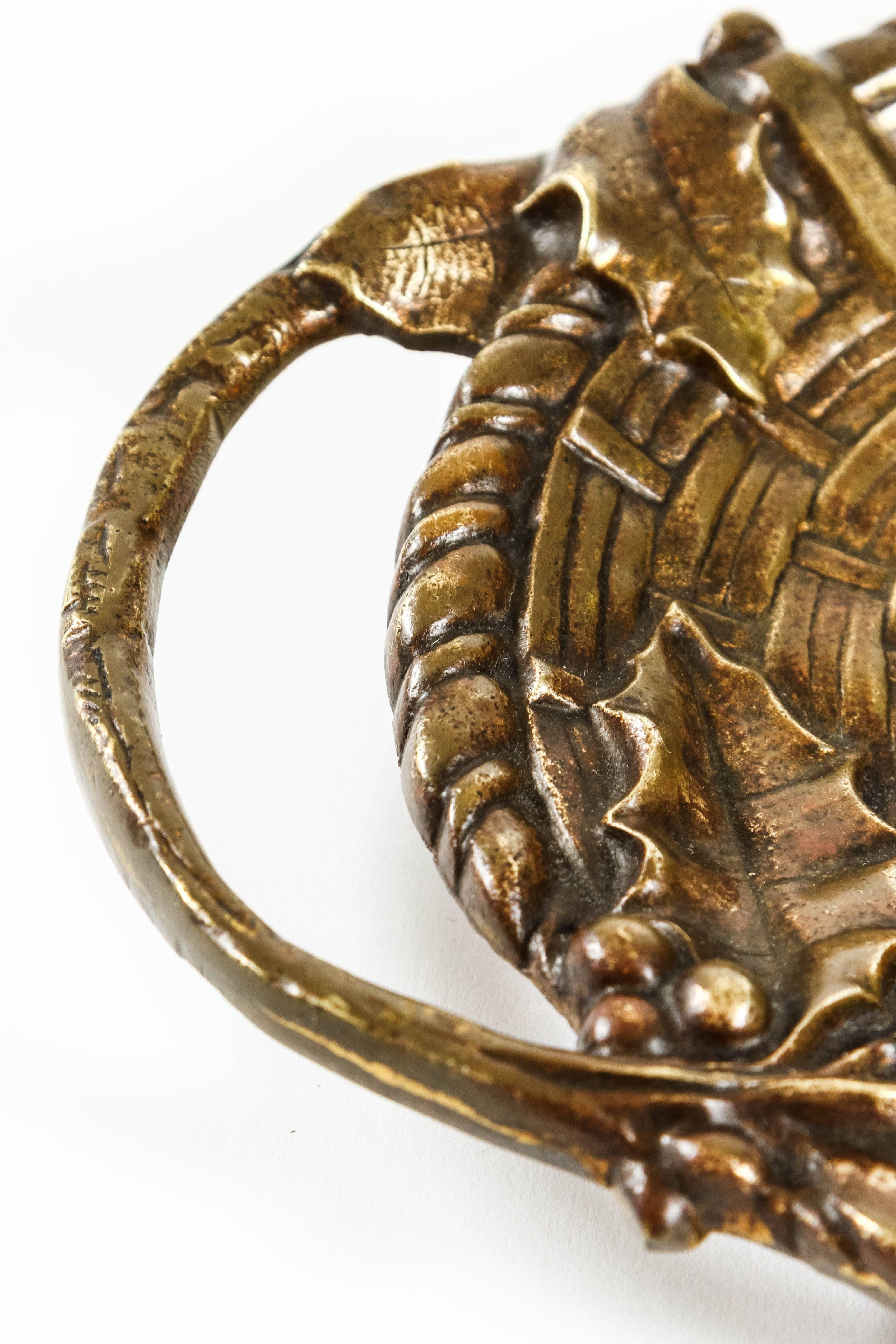 Heavy bronze vide-poche with fruit decor and a braid motif. Piece is signed: 