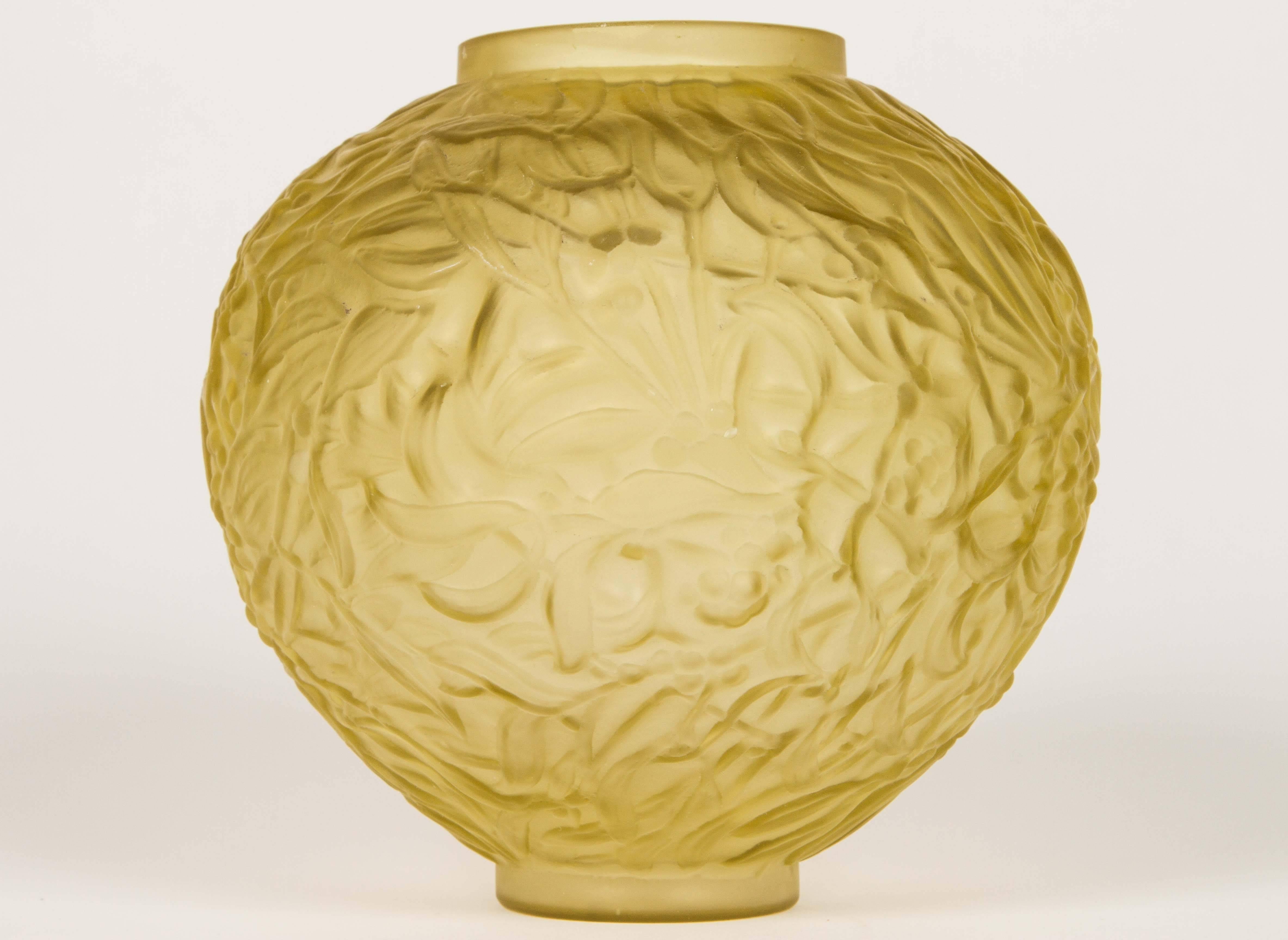 The 'Gui' vase by René Lalique. Elegant round glass vase with relief motif of leaves and berries of the mistletoe, on a satin base with engraved signature underneath: 