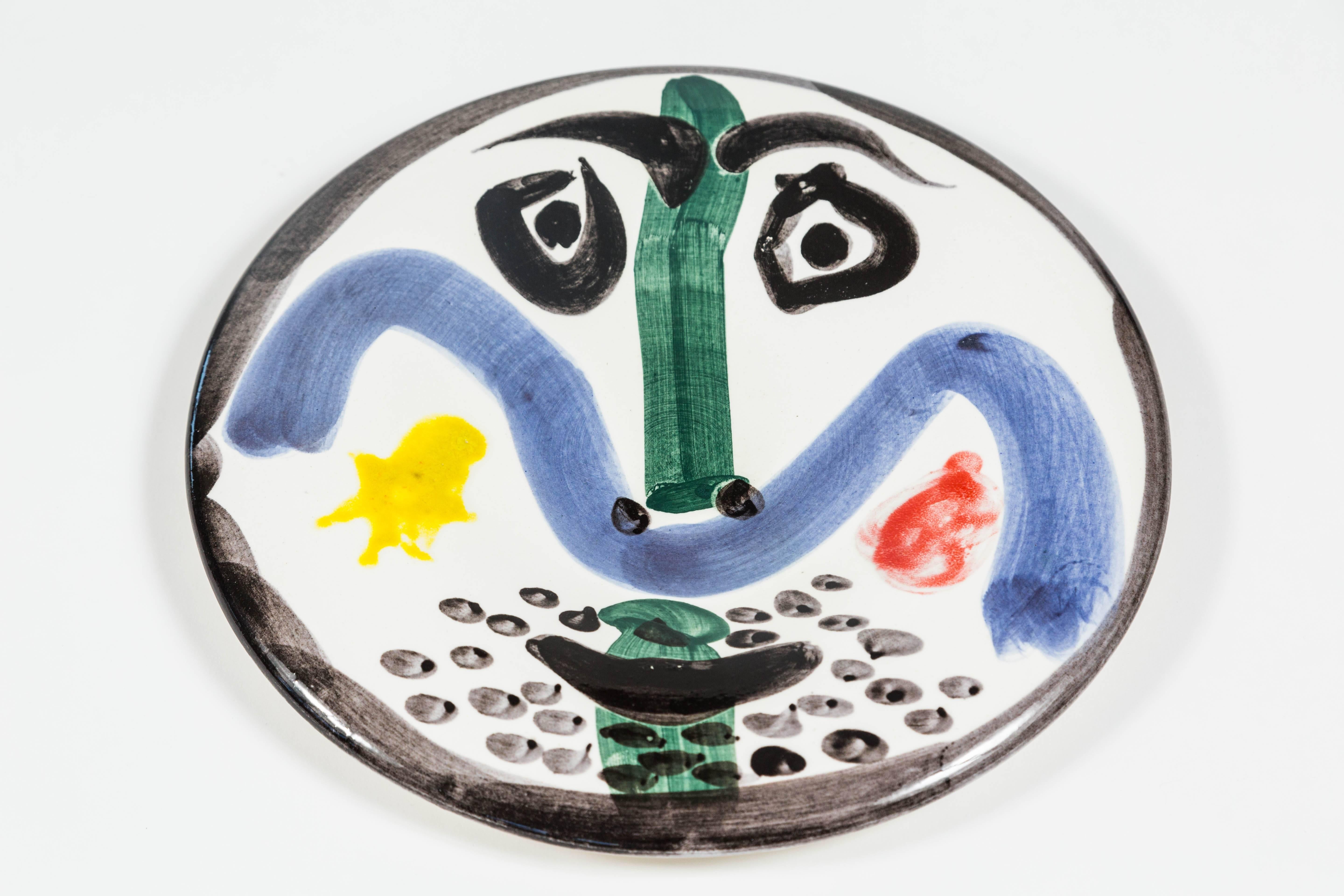 Beautiful fully glazed ceramic plate, numbered from the edition of 500. White earthenware clay, decorated in engobes and enamel. Underglaze blue, green, yellow, red and black. Marked on the reverse and numbered '130/Edition Picasso/From the edition