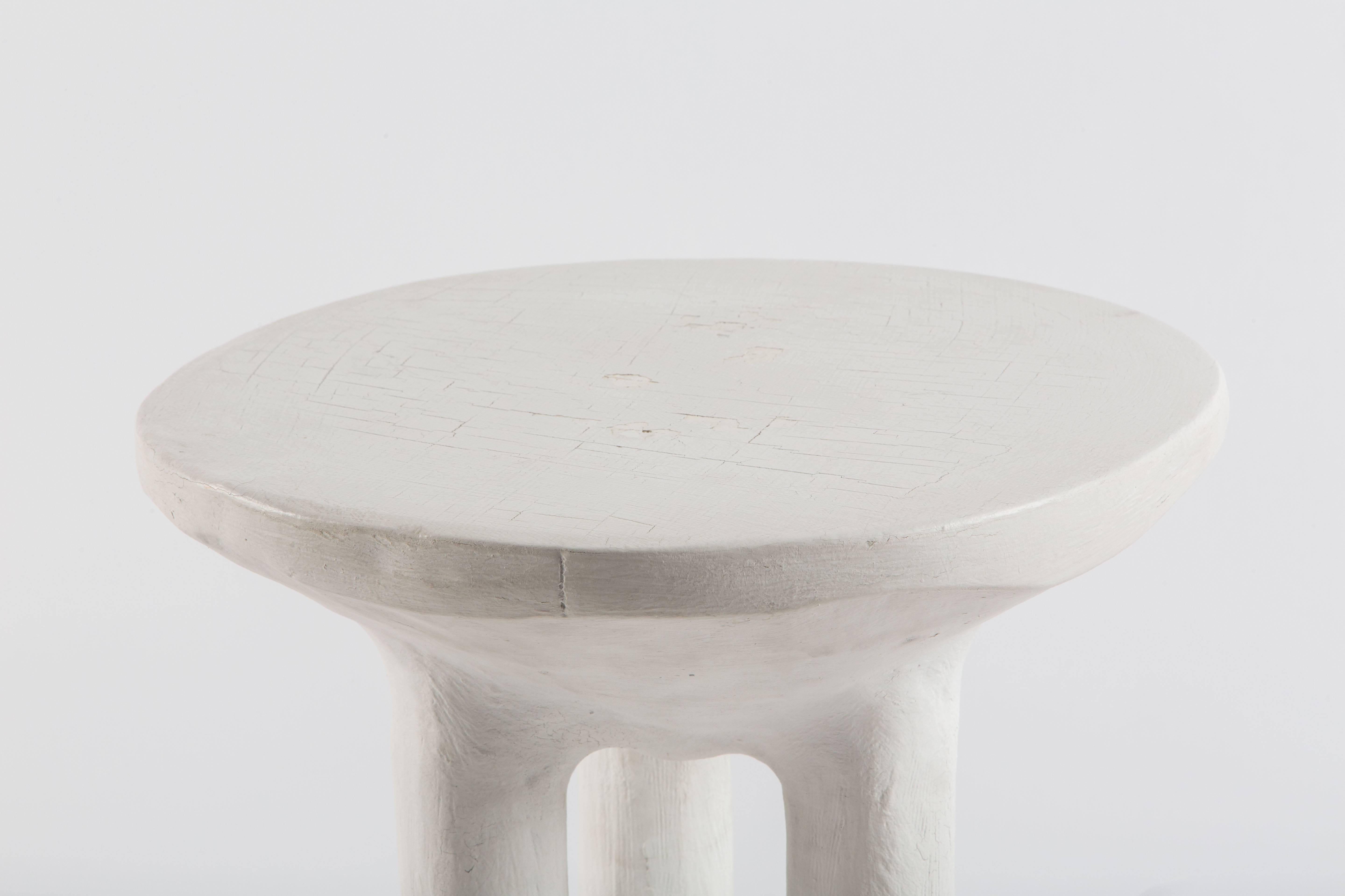 John Dickinson's iconic and playful African side table in cast Plaster of Paris with three Primitive legs. This example circa 1970s, tables shows signs of having been painted as the top shows the paint has cracked.

20 1/2 inches high. Fine