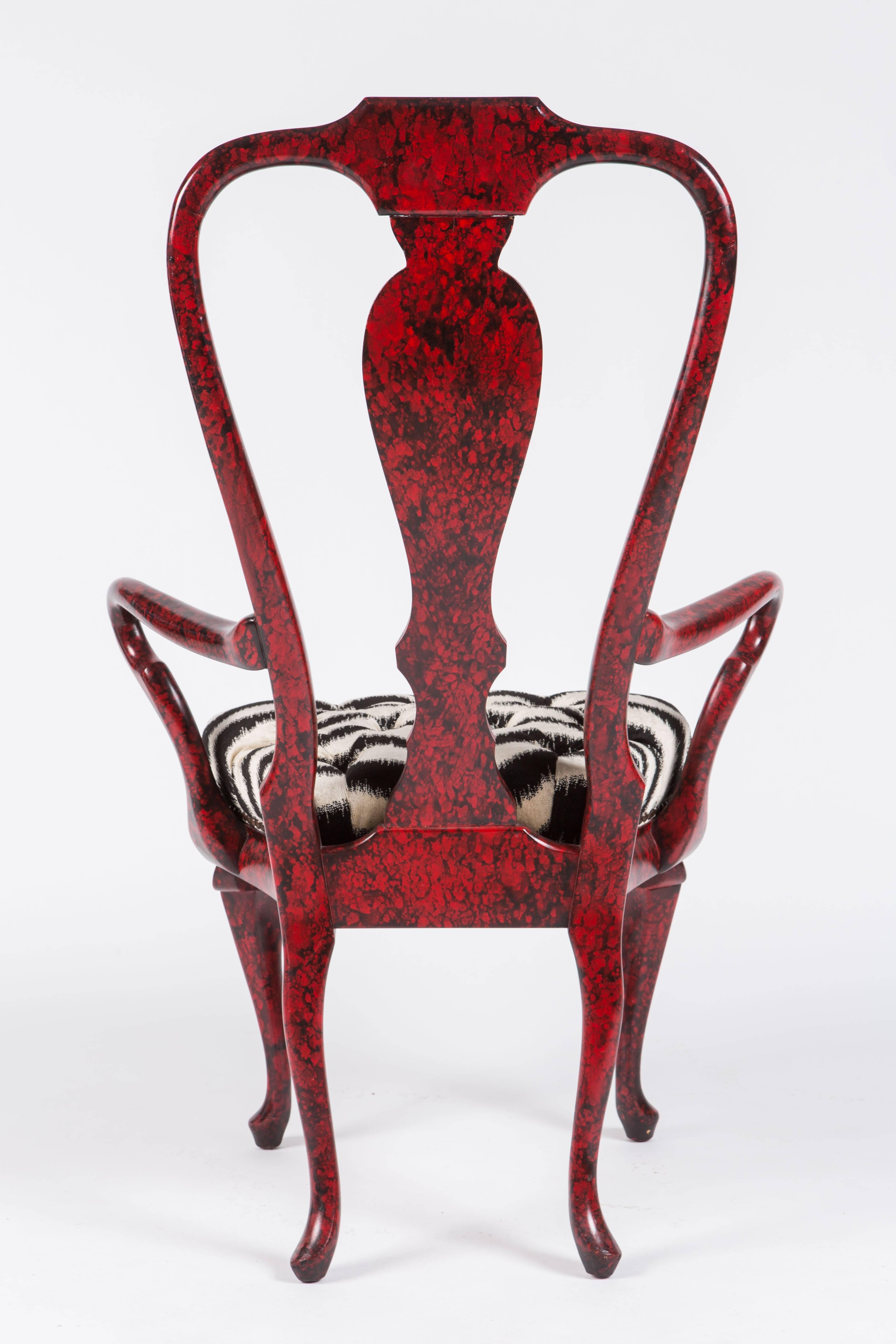Alice in Wonderland meets Queen Anne in this dramatic pair of armchairs by Phyllis Morris. The chairs feature a marbled red and black painted finish and tufted faux zebra upholstered seats finished with nailhead trim.