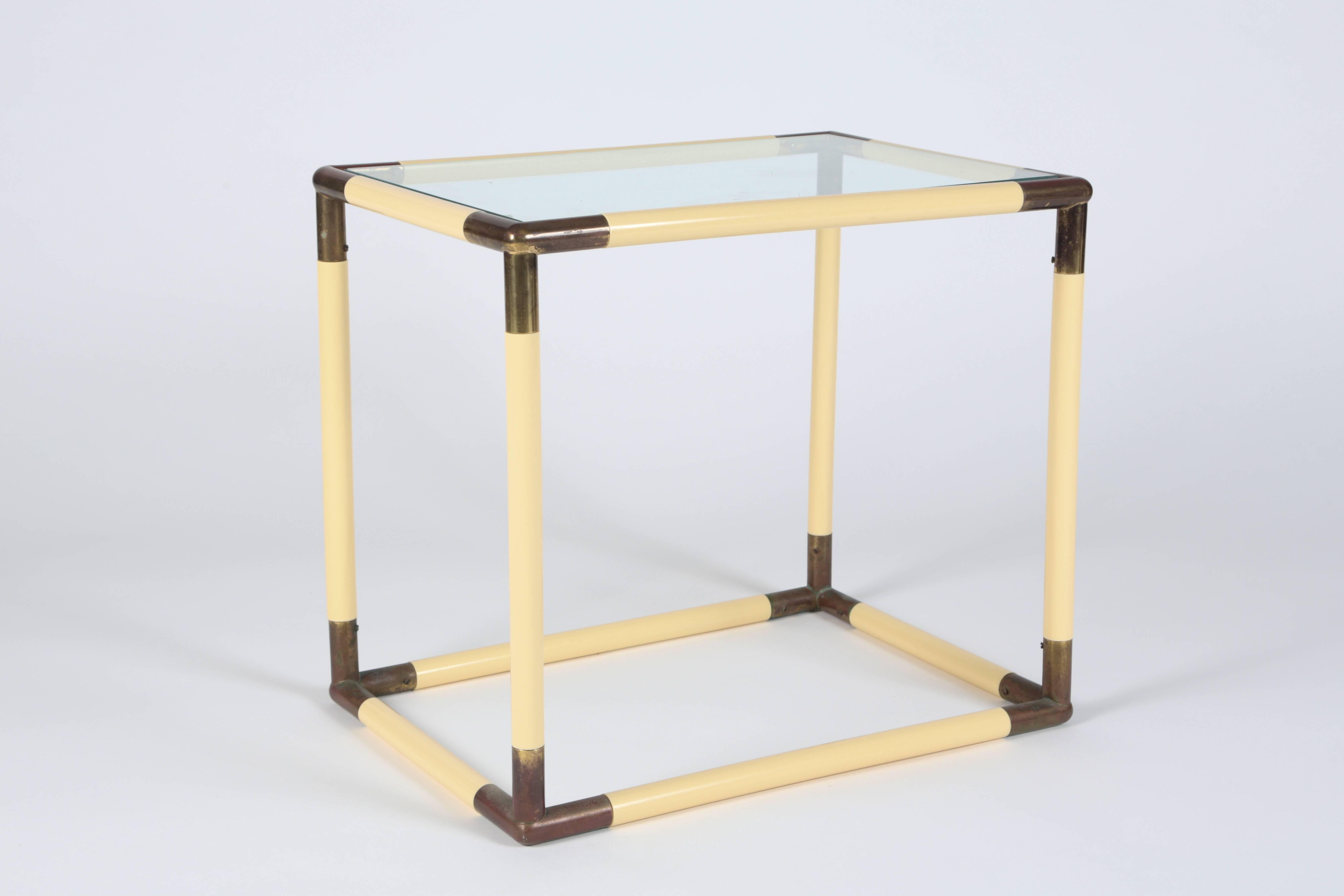 Fantastic geometric glass top table. Brass corner pieces connect 1 inch thick tubular segments simulating parchment. The brass has developed a wonderful patina.

We believe the table to be Italian in origin.

We are also selling the same table