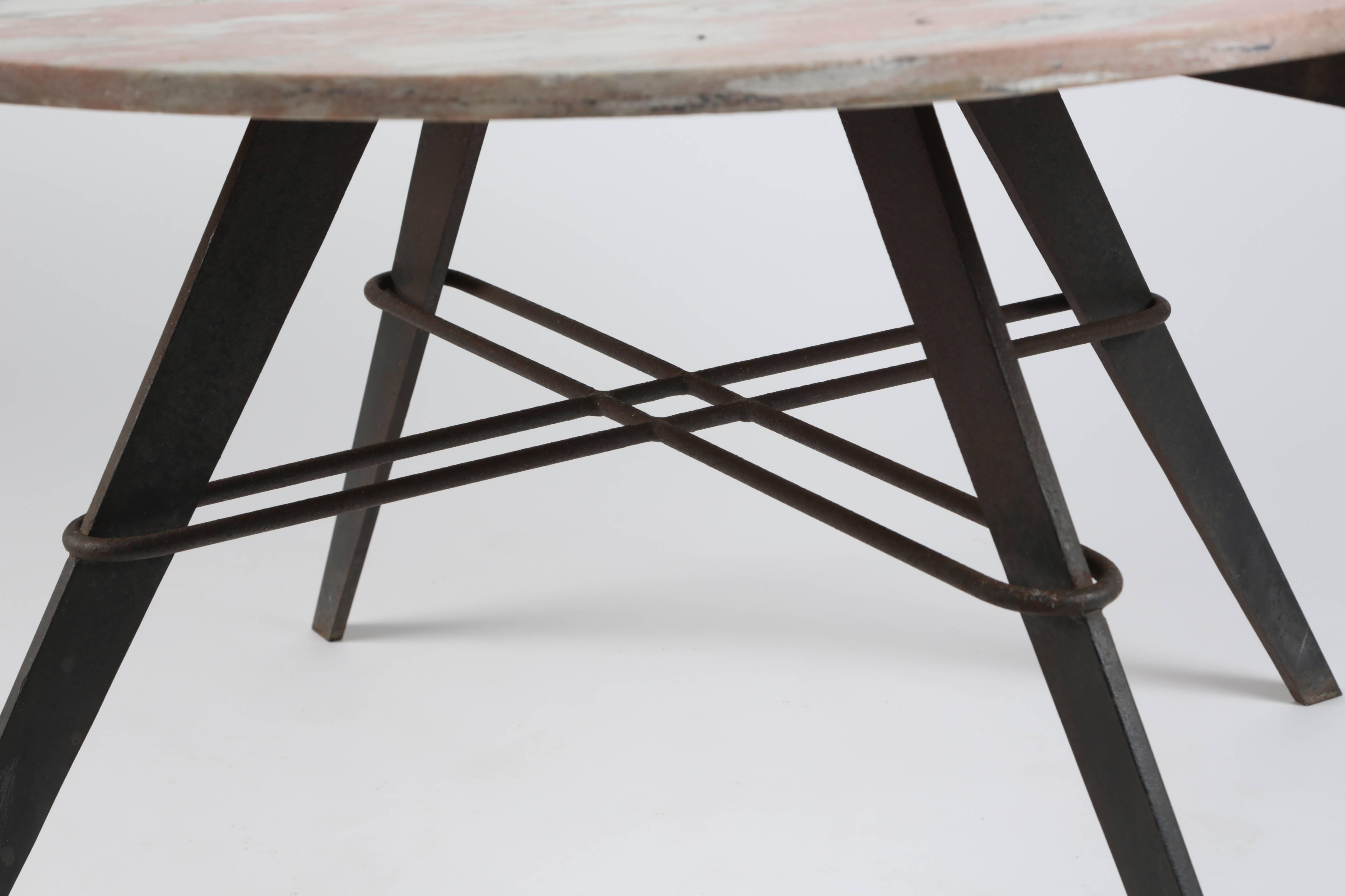 A fantastic iron and marble-top table by legendary Hollywood decorator and designer William 