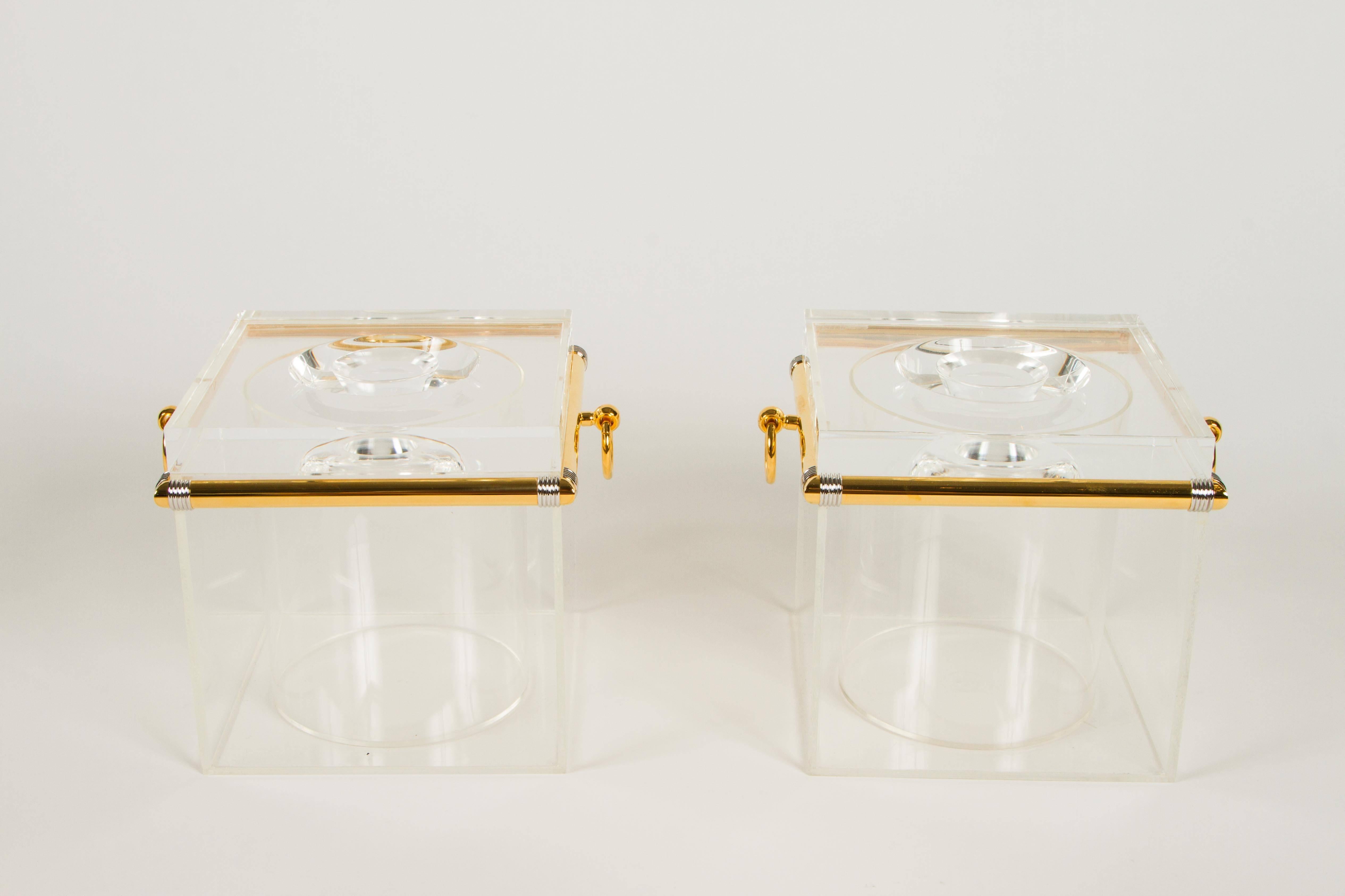 Uber chic pair of ice buckets no doubt of Italian origin. Fashioned from Lucite and finished with hardware in gold plate with contrast silver details at the corners. These buckets are high quality and totally stylish. There is on pair of gold plated