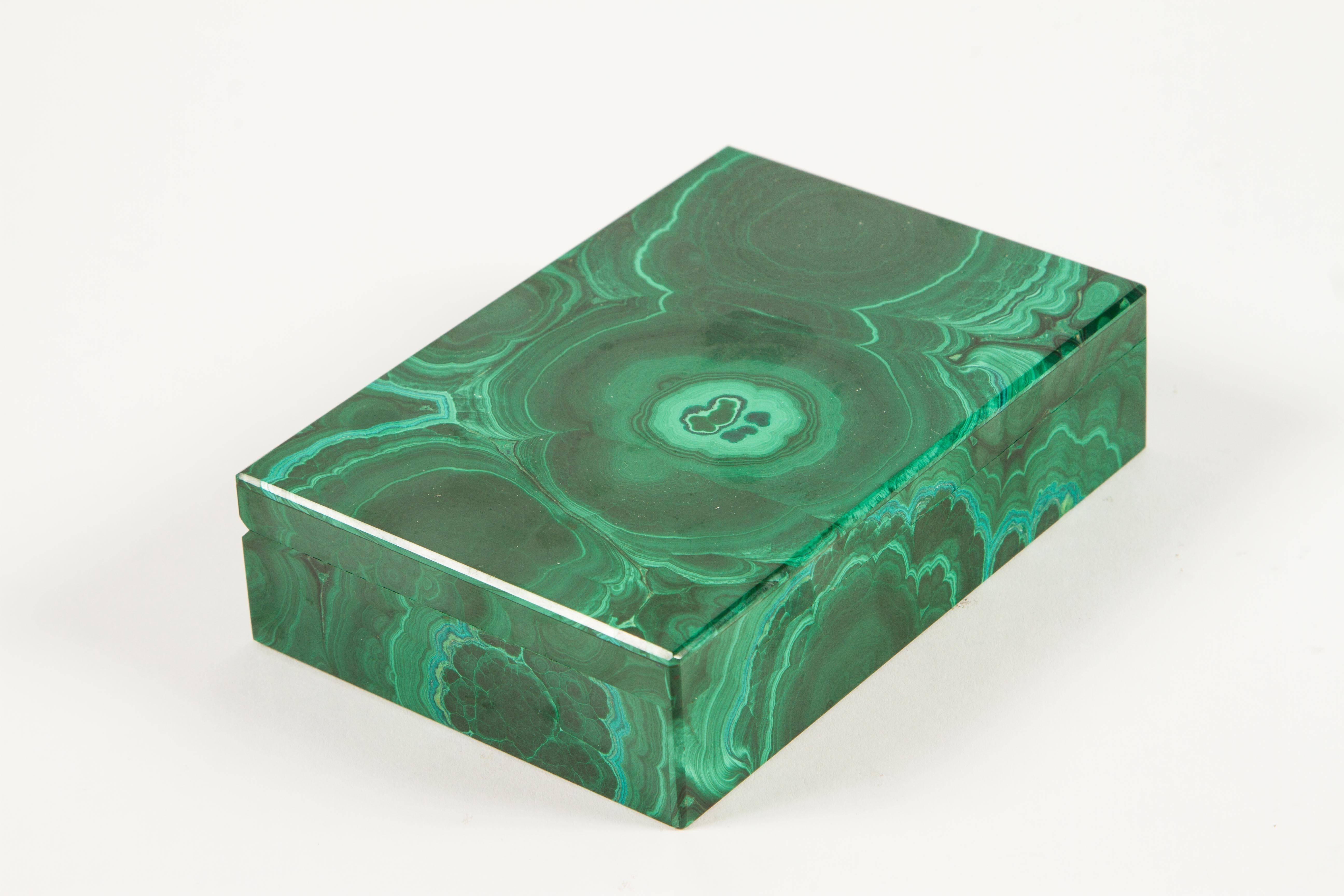 An elegant malachite box using full slabs of stone rather than being pieced together this is a special box. The interior is lined in black onyx and the fittings for the hinge are gold-plated.