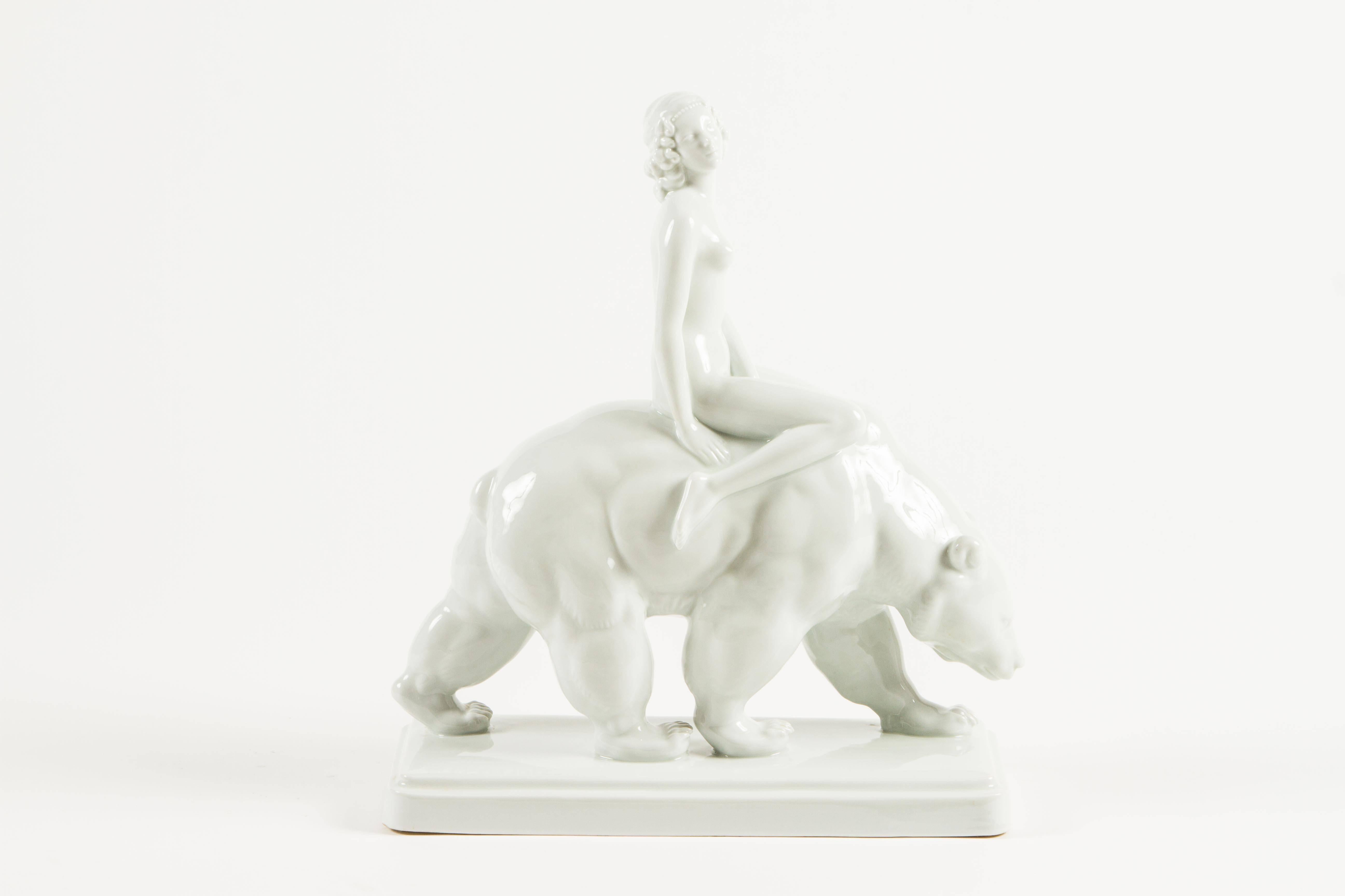 A wonderful Art Deco era figural group depicting a woman astride a polar bear. Standing nearly 20
