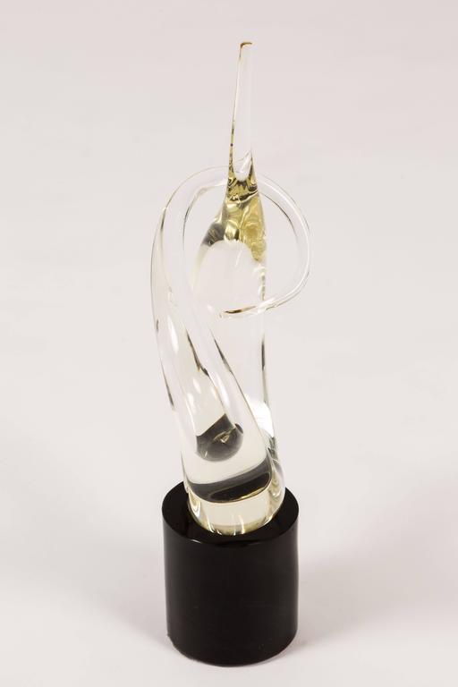 Wonderful small-scale Murano glass sculpture in clear glass on a black glass plinth. Lyrical and expressive, appears to be the work of Seguso and most often would have been signed with a label that is now gone. On the underside under the felt the