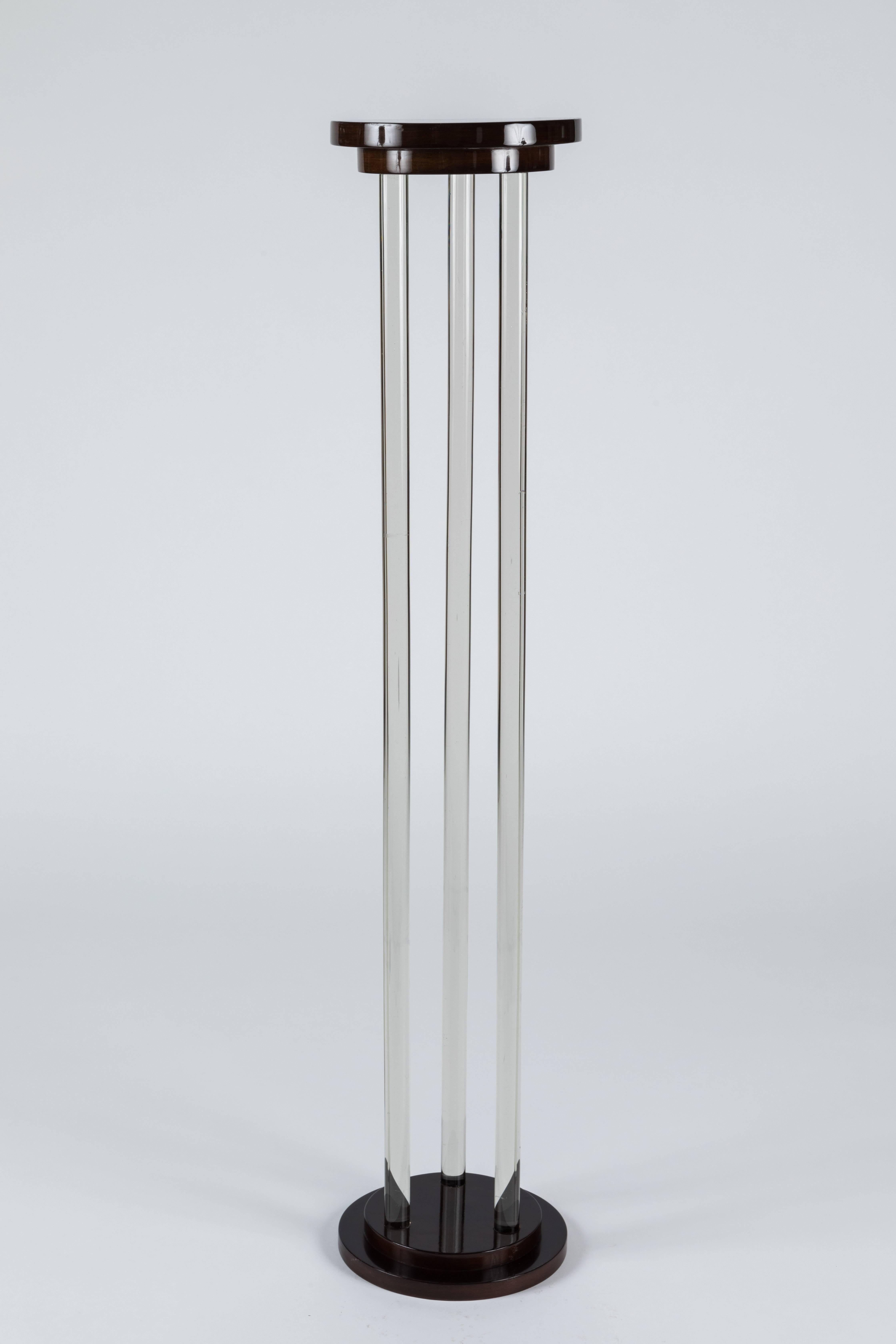 A lovely Art Deco pedestal featuring high polished wood elements separated by heavy duty glass rods.