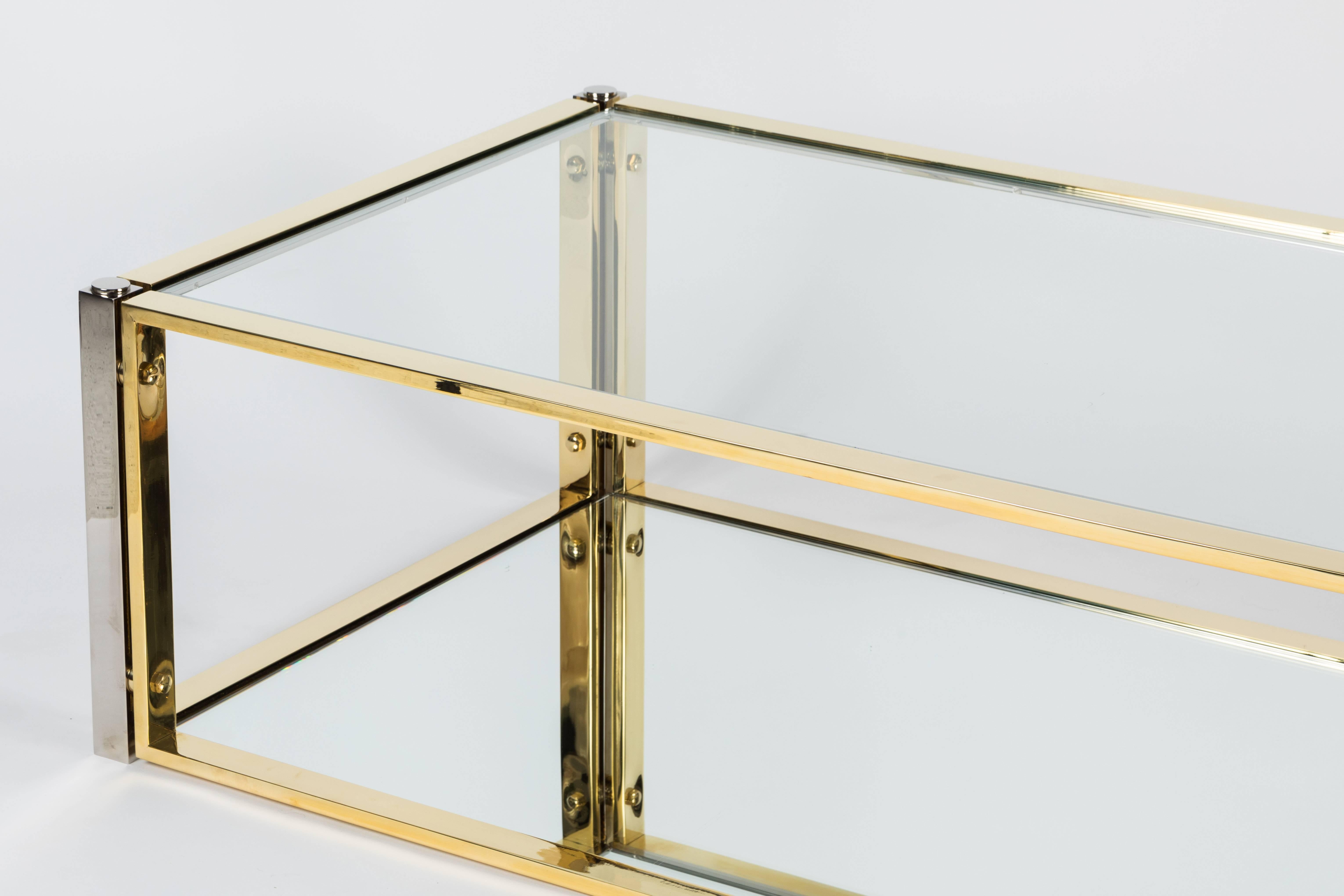 Super stylish rectangular cocktail table in a mix of polished brass and chrome. The bottom level of table is accentuated by mirror while the top is glass. Beautifully restored and ready to use.