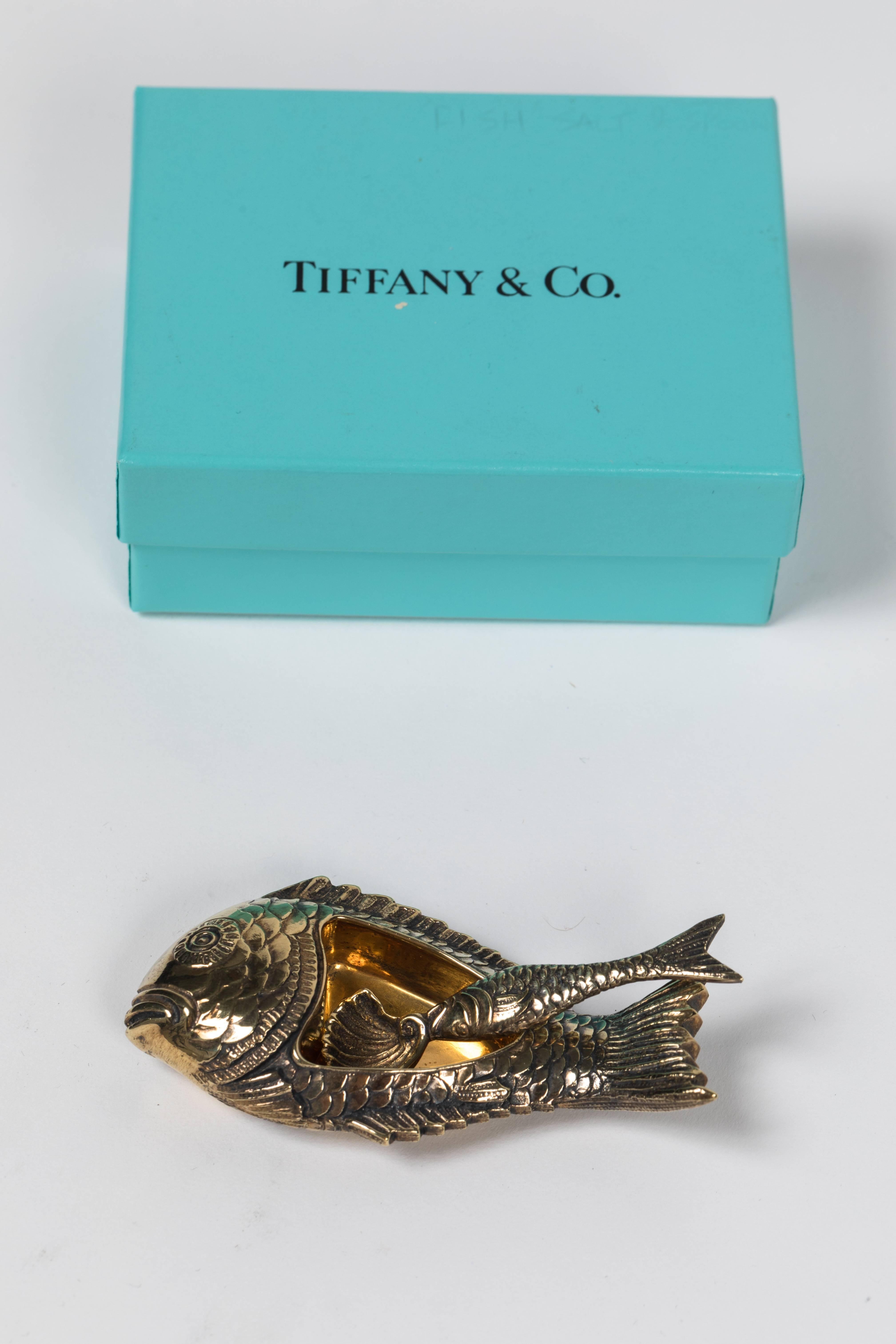 A vintage, yet timeless salt or spice dish in designed as a fish with a matching spoon. Stamped 