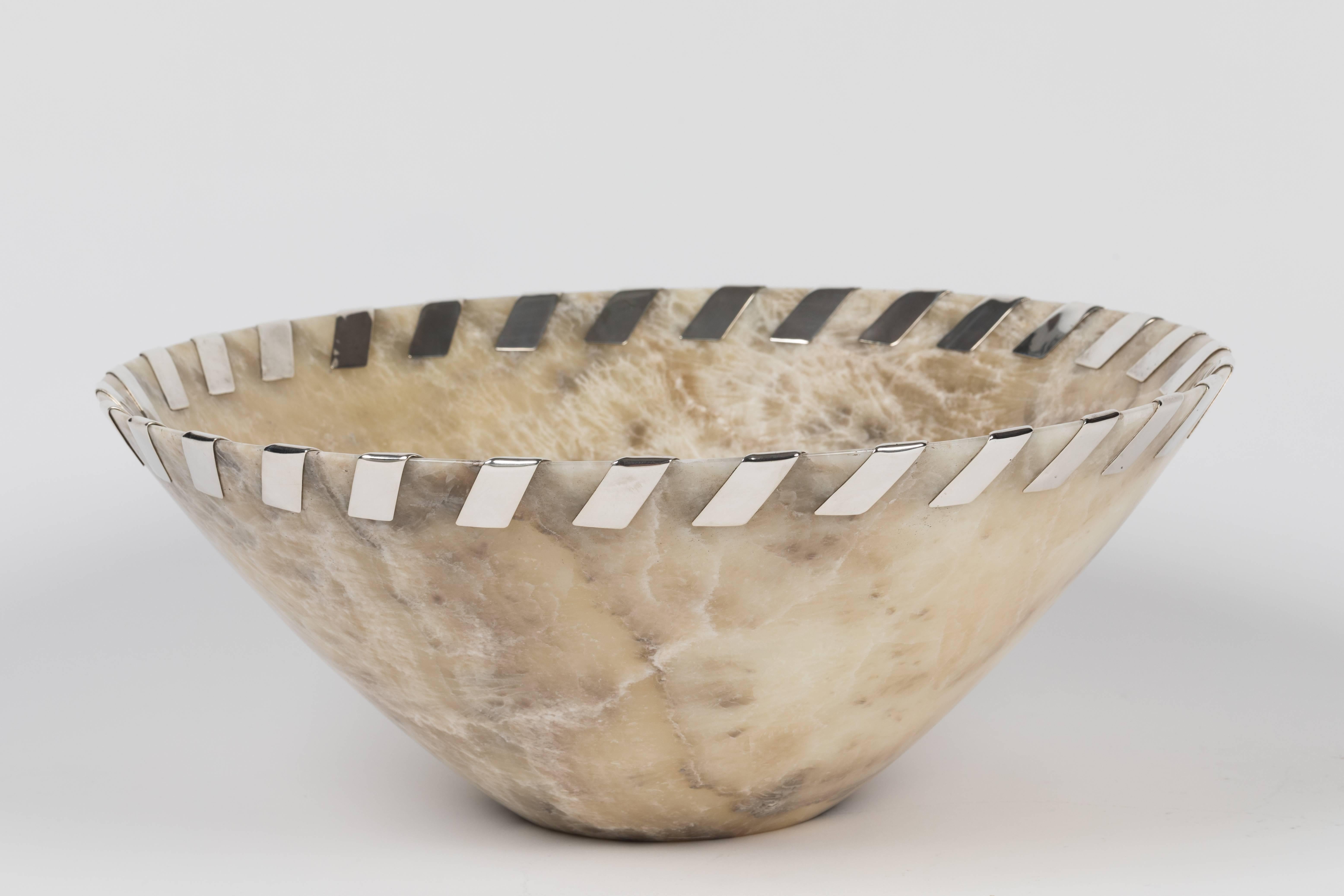 An impressive oversized bowl carved in creamy agate featuring a sterling silver ribbon 