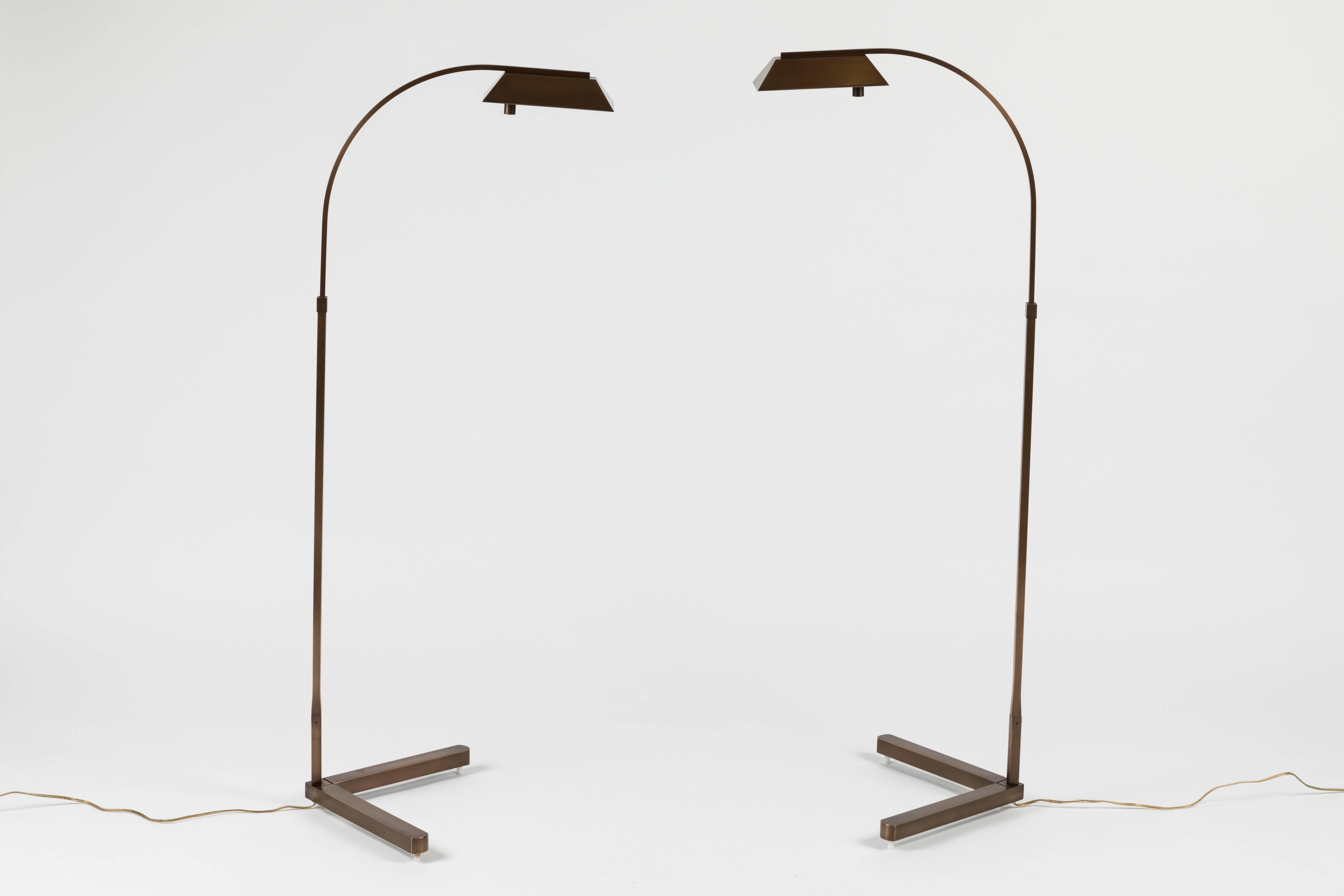 Beautiful pair of vintage task lamps by Casella Lamps. The pair have a patinated brass finish. Lamps adjust in height as well as side to side. Manufactured in Sacramento, California. 

 
