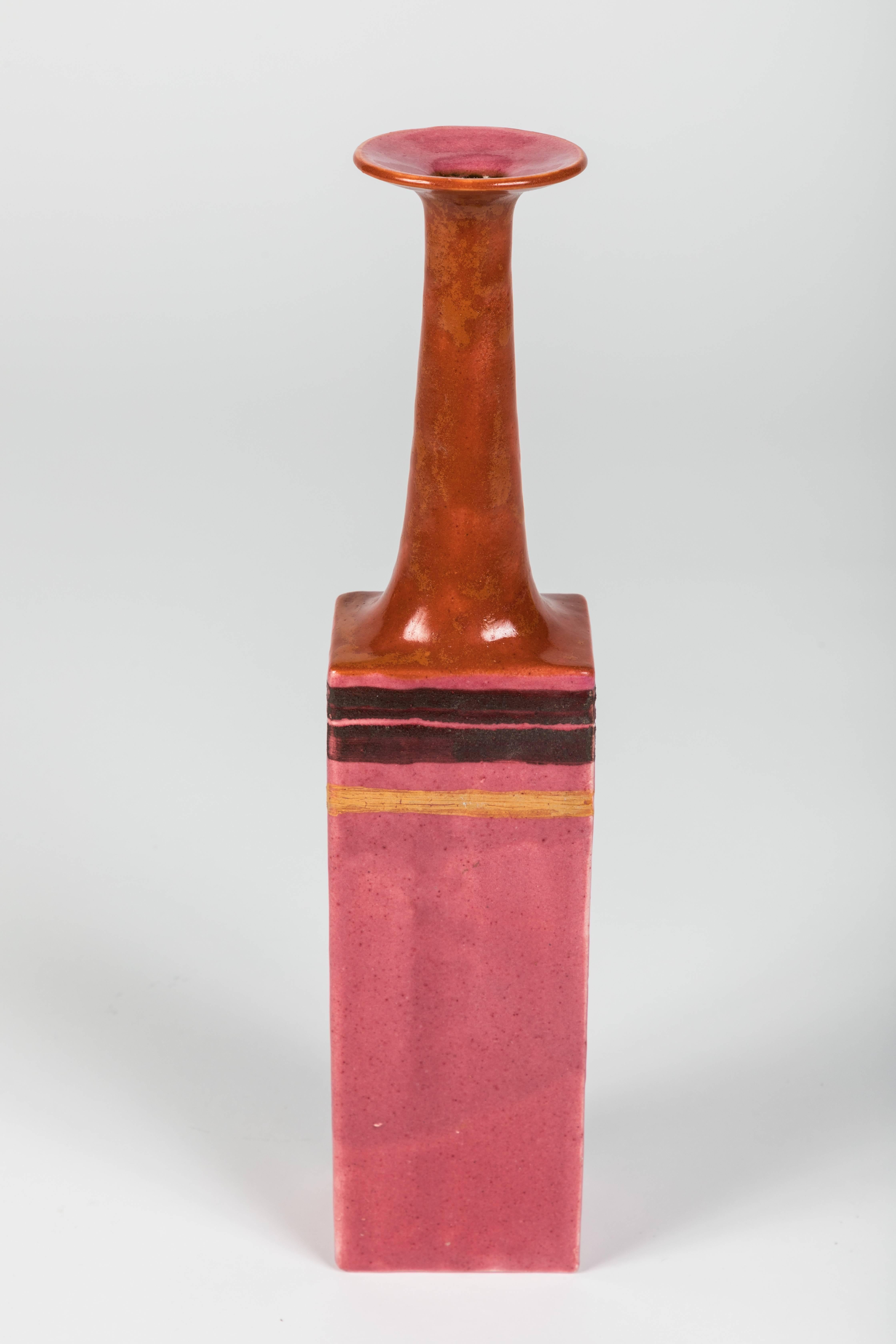 Ceramic vase by the Italian ceramicist Bruno Gambone, (circa 1970s). This graceful narrow-opening flower vase is a work of art. With a modern rectangular base and lean, elongated neck its shape has its origins in Primitive works. Uncommonly