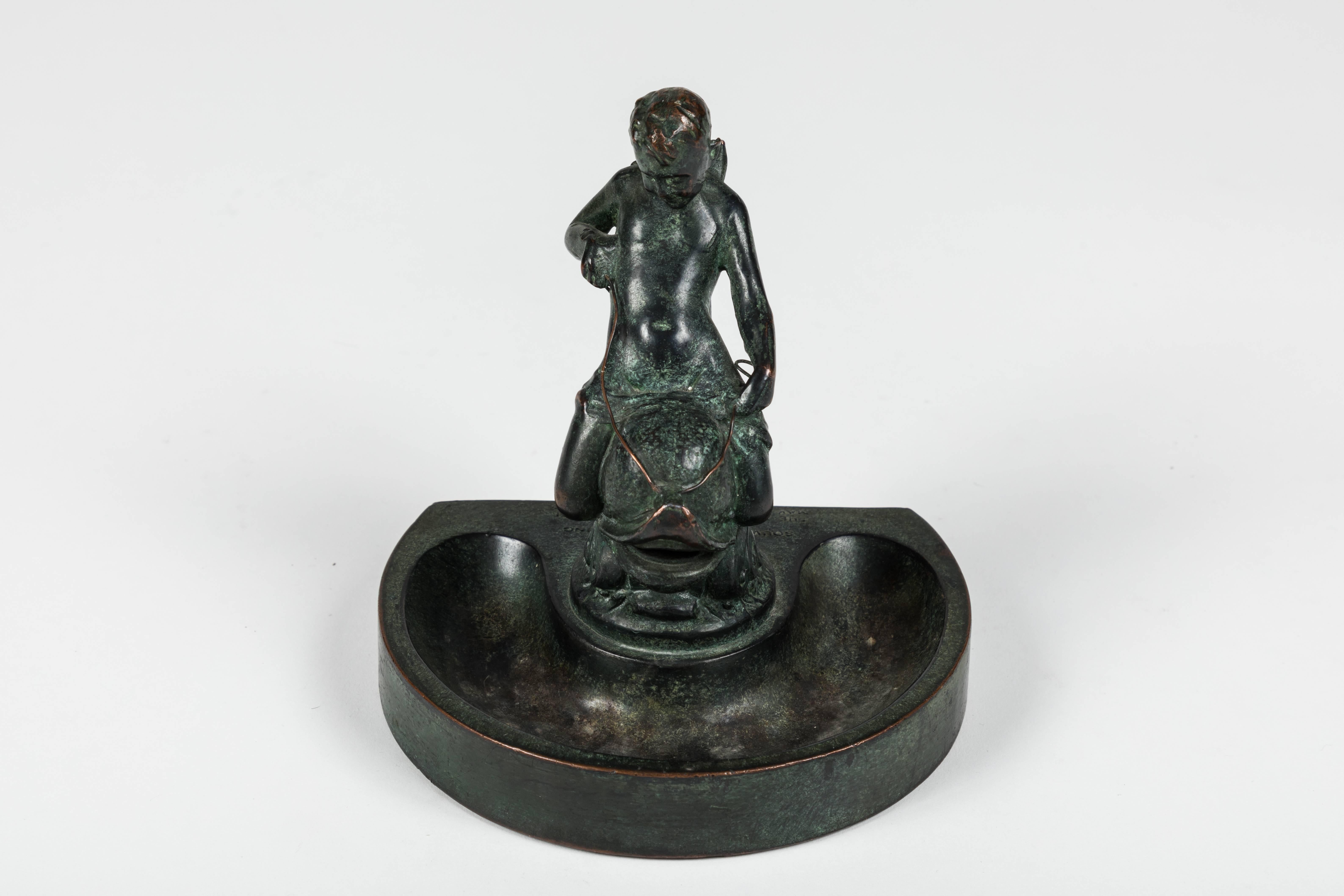 A rare bronze ashtray featuring a boy on a dolphin designed by Frederick Cleveland Hibbard. A souvenir that was given to male guests at the opening gala of the Stevens Hotel on May 2nd, 1927 (the women were given, 