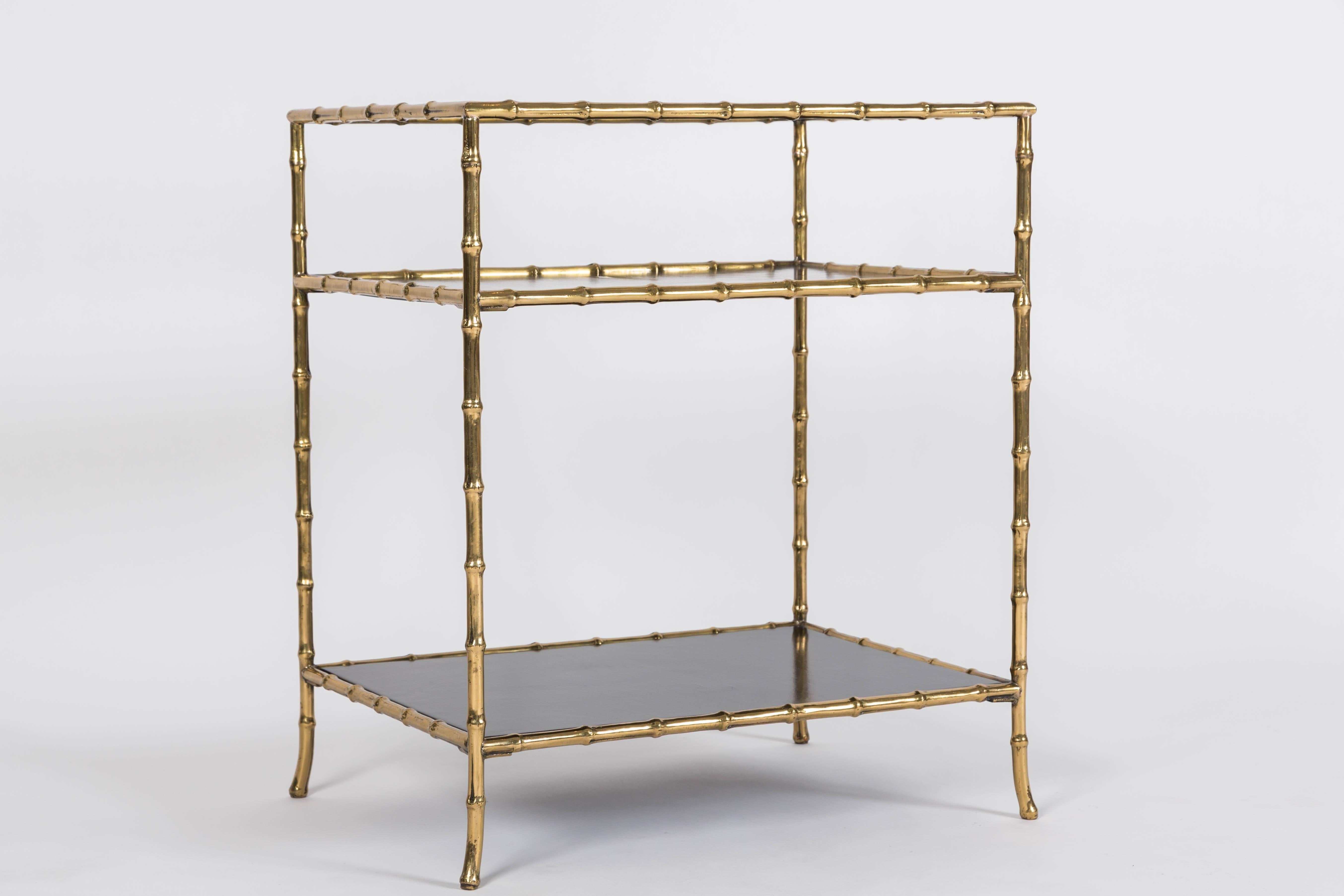 Polished brass faux bamboo frame with a gallery around the top shelve and polished black shelving inserts are the highlights of this lovely bar table. This table has a timeless design that complements multiple styles and decor.


 