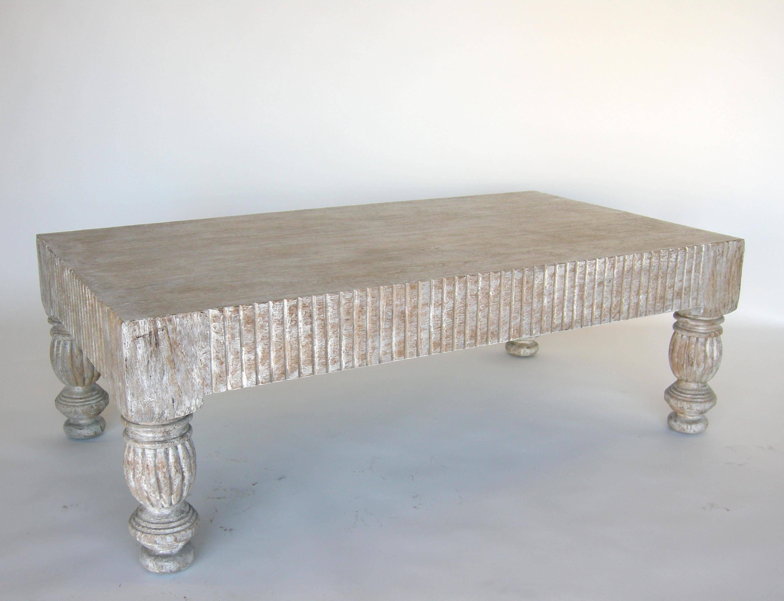 Custom coffee table with fluted apron and carved legs. Can be made in oak, teak, walnut or mahogany in a variety of sizes and finishes. Shown here in teak, with a grey driftwood and white weathered finish. Made in Los Angeles.

As shown 50 x 30 x 20