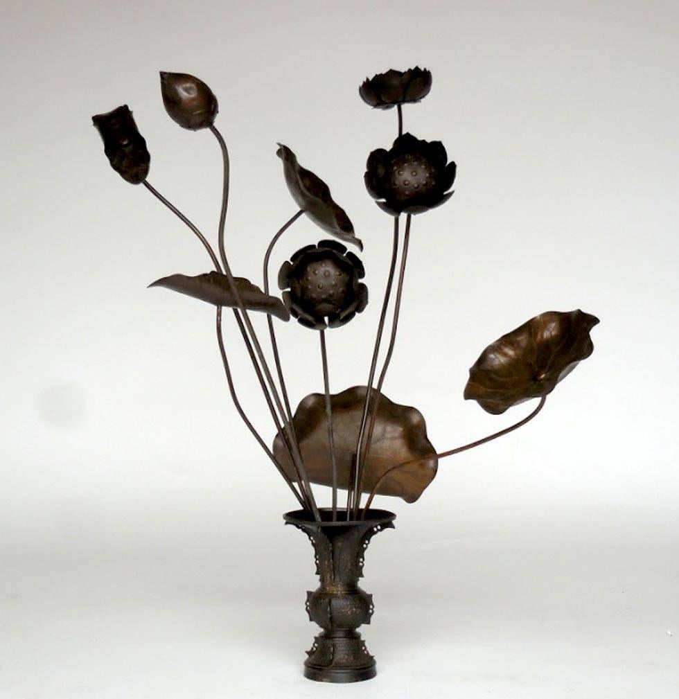 Japanese bronze temple flowers with original bronze vase. Graceful and elegant. Flowers are removable, each having a long stem. Old dark patina. Delicate flower design. The largest bloom measures 11.5