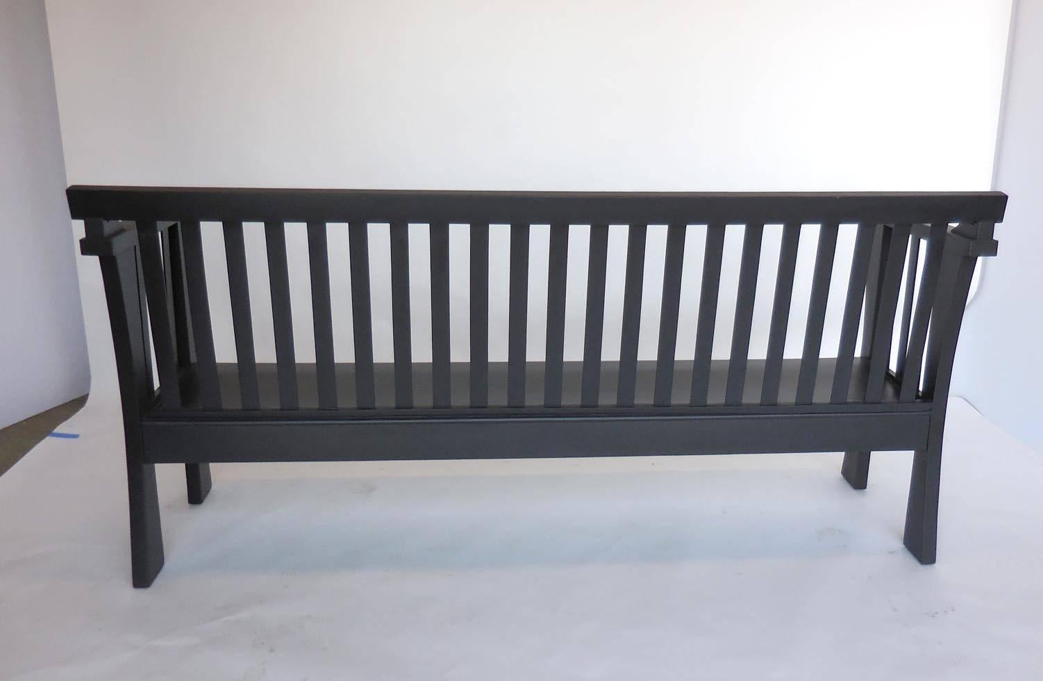 Upstate New York early 20th century wooden slat back bench. Very comfortable for waiting for a train! Modern, clean craftsman design, refinished in matte black. Striking.