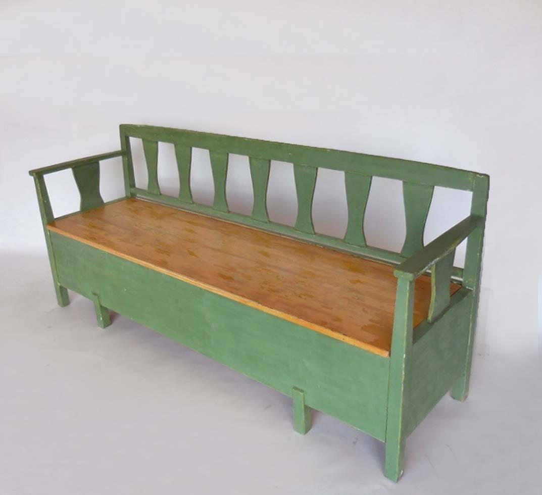 Swedish painted kokssoffa - (kitchen sofa) used as a bench in a farm kitchen as well as a pull-out bed for the house maid. Seat lifts up for storage and front pulls out for using as a bench. Great green color and worn patina. 