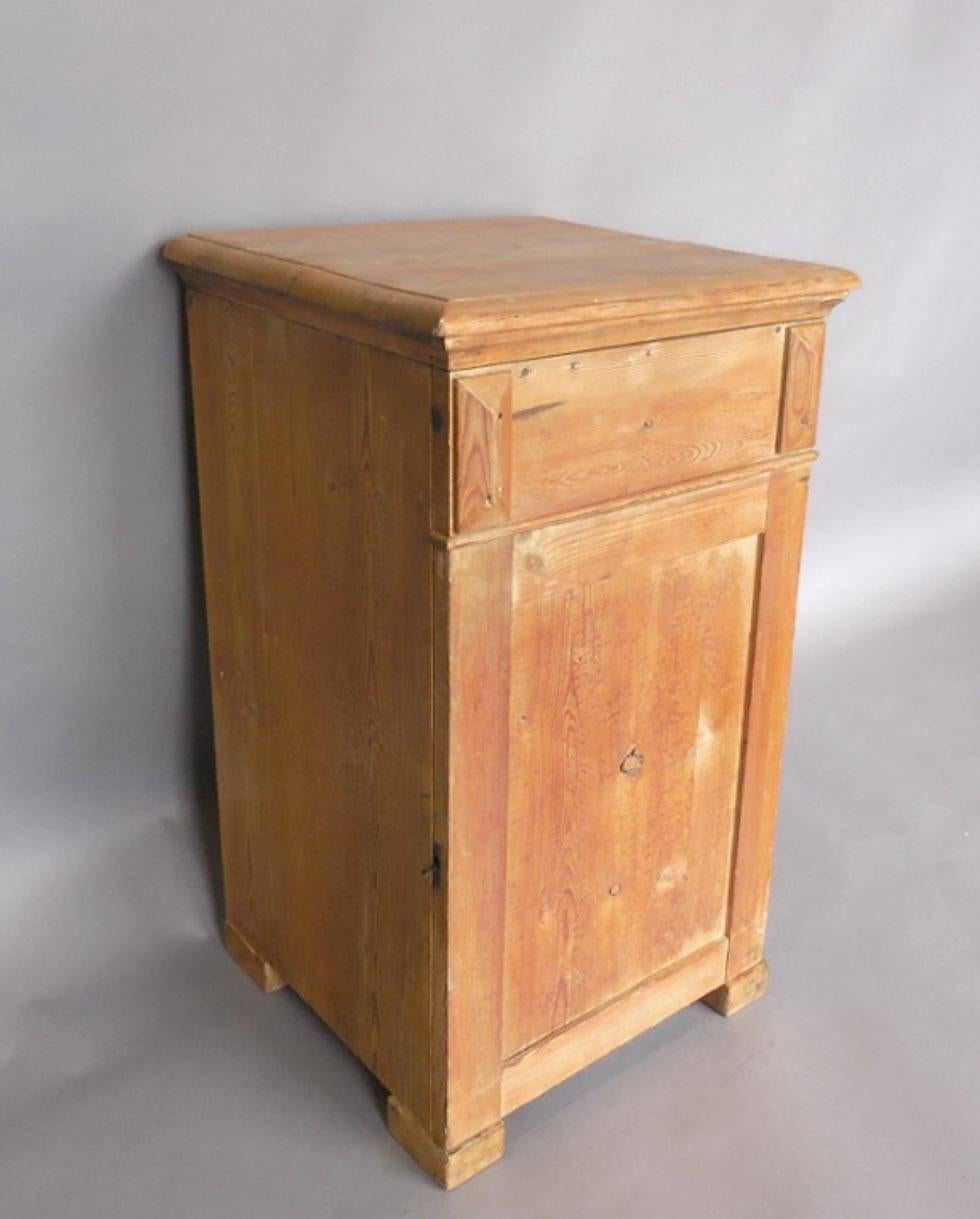 19th century Swedish natural light pine nightstand or cabinet used for holding a washbowl. Top lifts up to place wash bowl and door opens to interior drawer and cabinet space where the potty probably was housed.
All original.