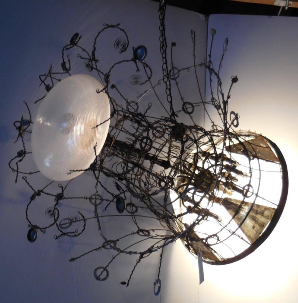 Whimsical recycled materials fantasy steampunk chandelier!  A rocket taking off leaving a trail of light! made by Matthew Culbert