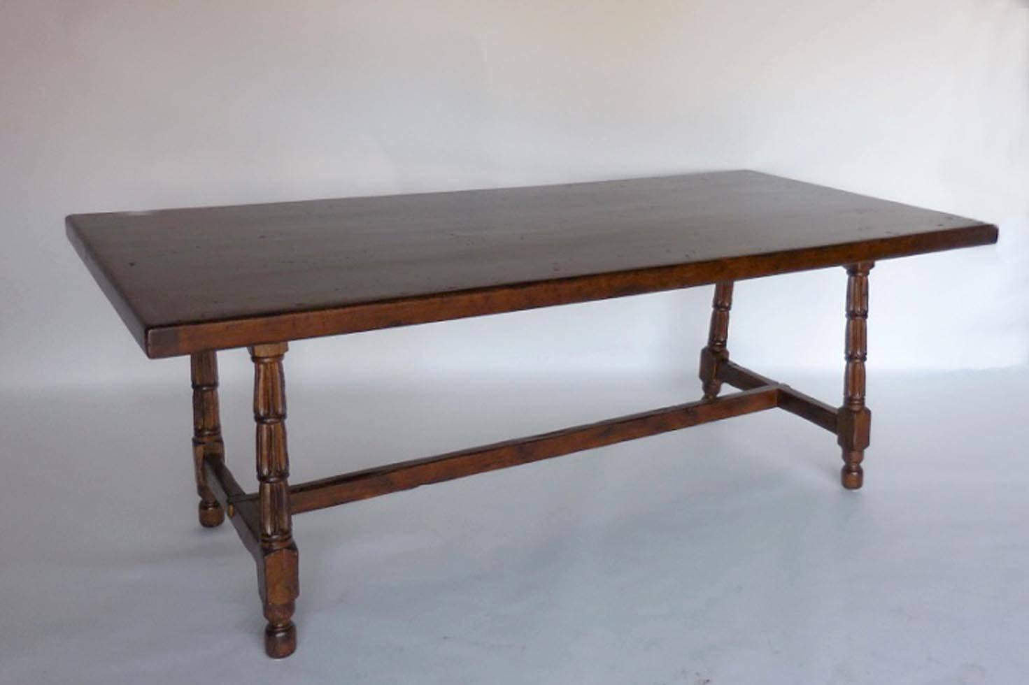 Walnut table or desk with carved fluted legs. Medium walnut finish with some applied distressing. New construction.