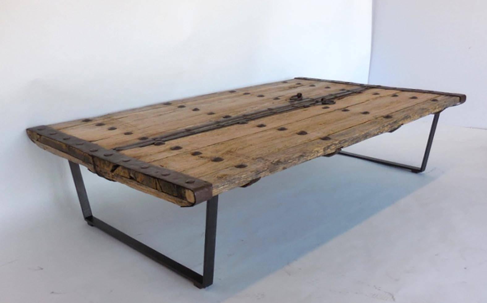 18th century elm doors with old nails from Japan upon contemporary hand-forged iron base. Good weathered grey-light brown natural faded finish. Handsome table, smooth and beautifully worn. Sturdy and functional. Original chain hardware door closure