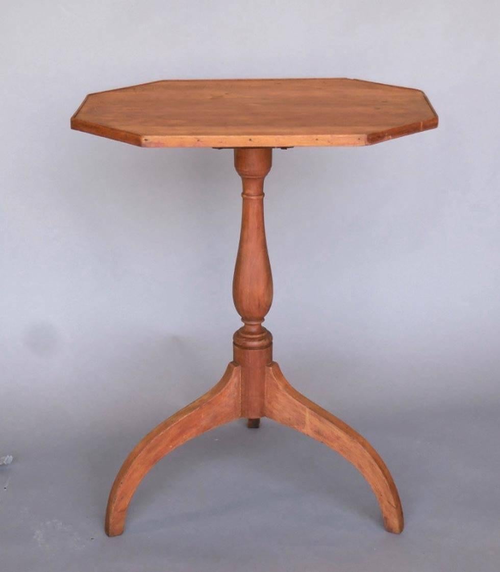 19th century cherrywood candle stand from Massachusetts. Sweet, rustic piece with some old carved writing in the top. Sturdy, functional and with natural patina.