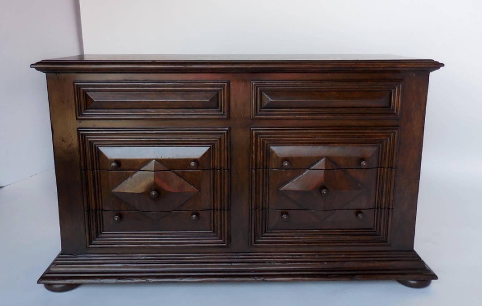 Majestic chest of drawers with cascading base ending in bun feet, raised diamond pattern on drawers. Two pencil drawers with hidden pull-out handles and six larger drawers with knob pulls. Can be made in custom sizes and finishes. Shown here in a