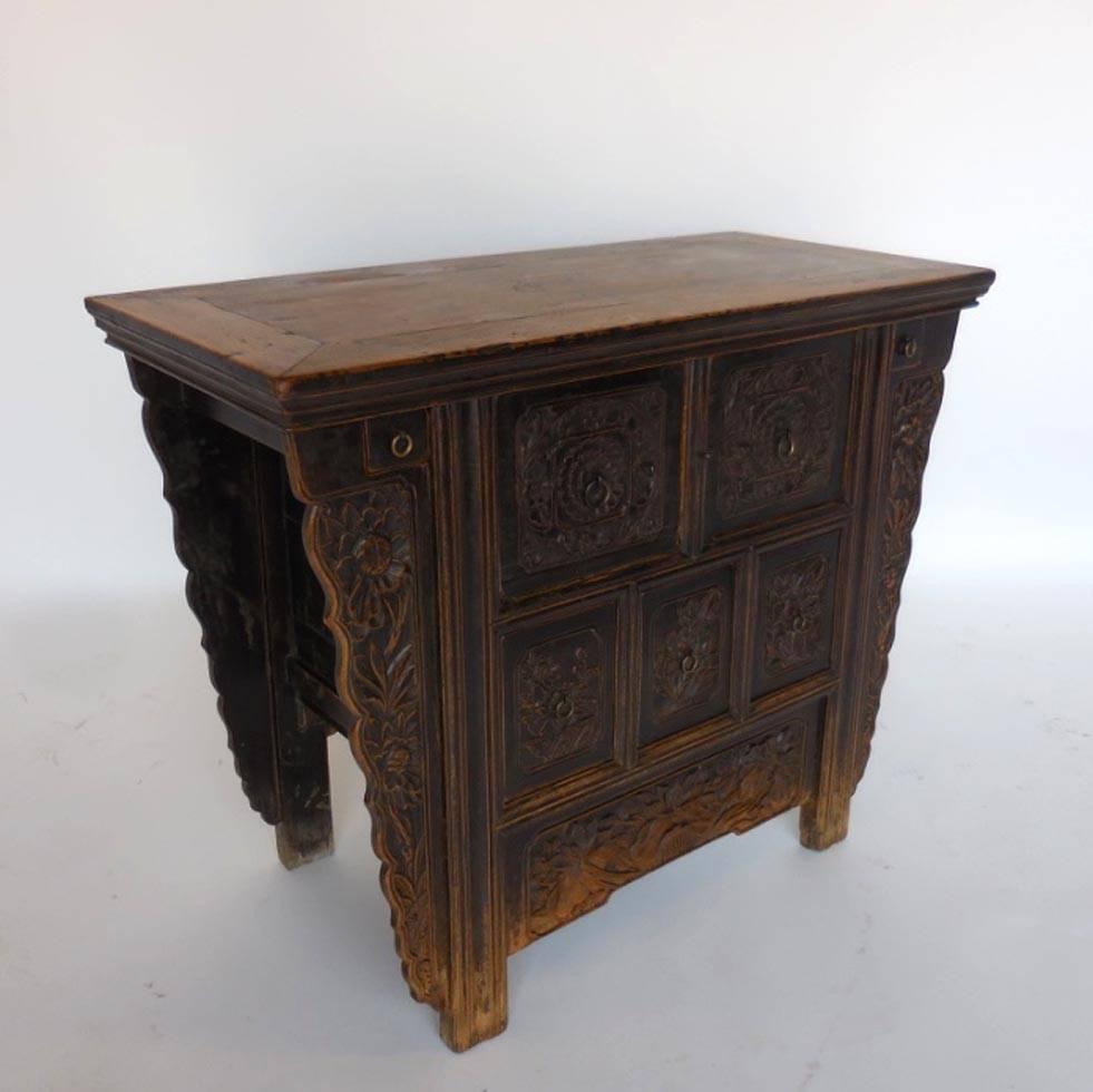 Late 18th-early 19th century beautifully carved altar table with seven drawers. Two small incense drawers and five larger drawers, all original hardware. Elm wood. Lotus and peonies motif. The patina is lovely and in excellent shape for its age.