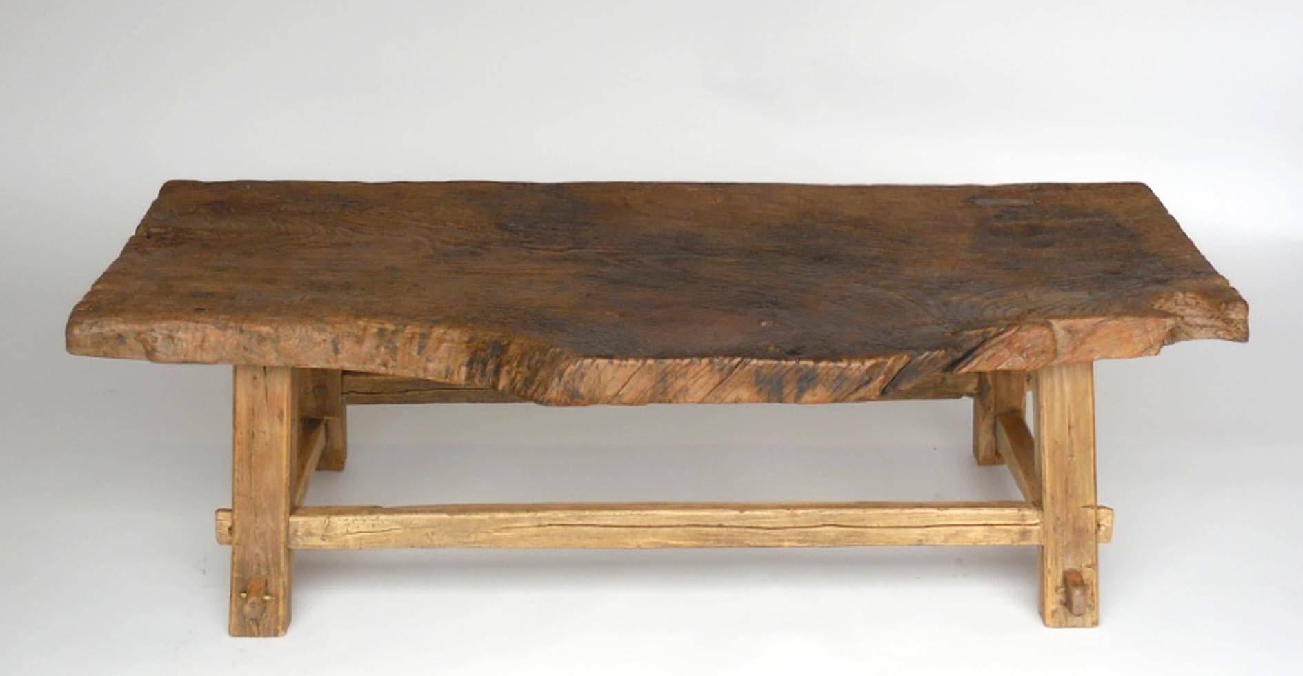 A 200 year old Northern Japanese elm low table/bench. Edo period. One slab of live edge wood atop mortise and tenon legs. All original, 3" thick top. Natural patina.