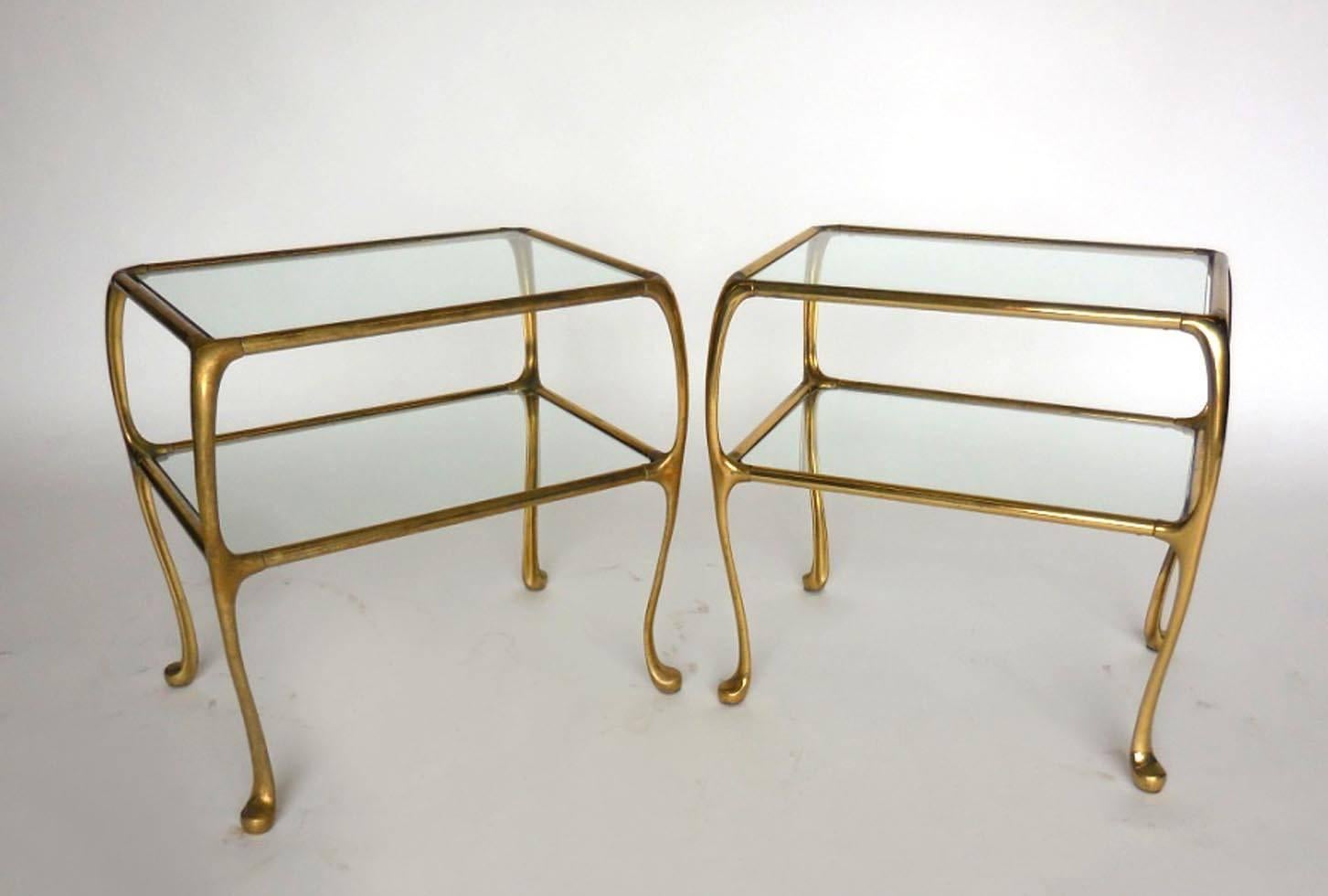 Mid-Century Argentinian thin profile brass side tables with glass tops and shelves. Tapered and modern Queen Anne leg.