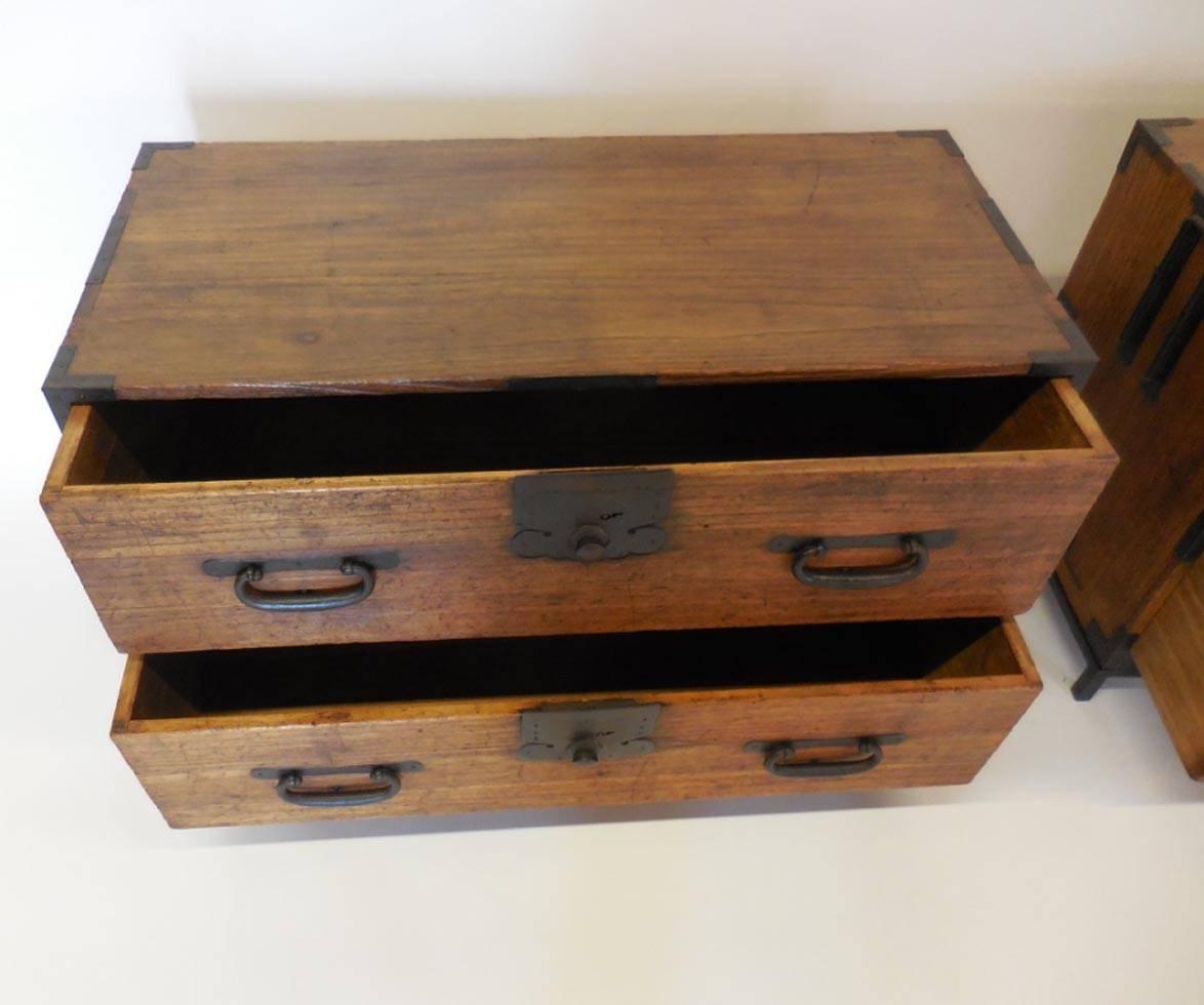 19th century kiri wood Tansu chests on custom iron bases. Original heavy hand-forged hardware. All original. Bamboo nails. Sturdy and functional. Works well as night tables.