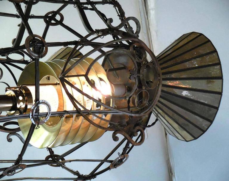 Professor Baron Von Pfam's solar wind rocket ship - The Kenmark five designed by Matthew Culbert.
Whimsical light of assembled old, recycled iron, camera equipment, pieces of vintage chandeliers, pink brown glass crystal and fleur de lis. Twisted