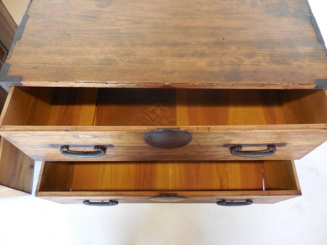 Pair of tansus on custom iron bases. Both have two drawers each, all original hardware, bamboo nails. Very functional. Make a perfect pair of nightstands! Traces of red paint. Smooth to the touch.