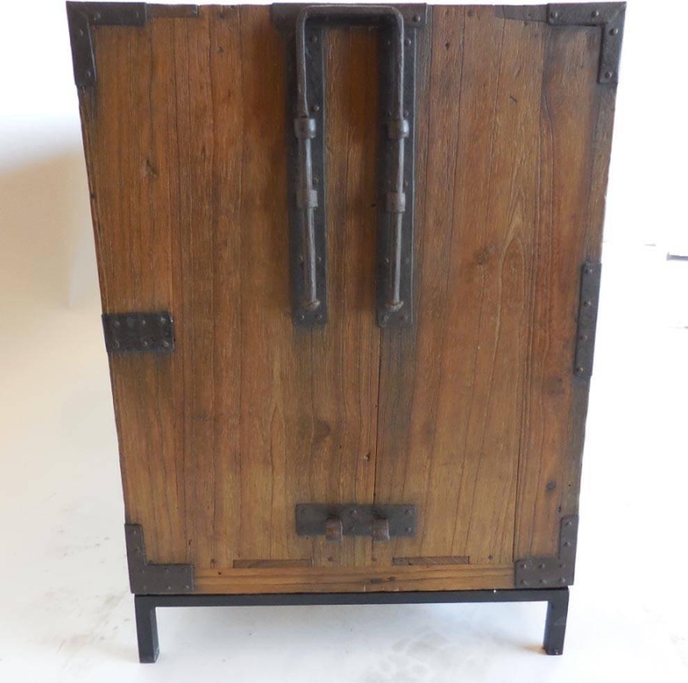 Beautiful hinoki wood 19th century tansu that can be either stacked or separated as shown in photo. Comes with custom hand-forged iron bases. All original hardware, great patina. Functions very well as nightstands, side tables or as chest of