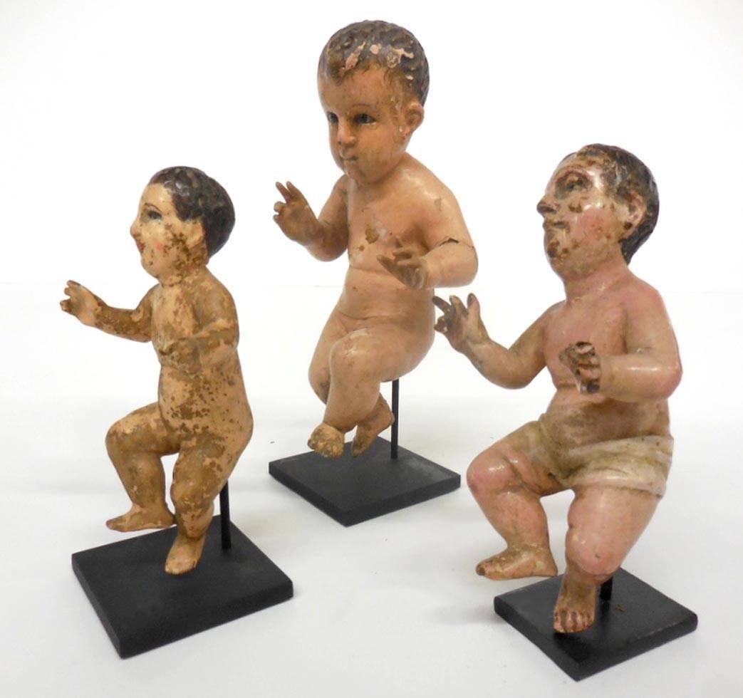 Intricately carved and painted, polychrome over cedro wood, baby boys or nino santo, on custom bases. Left is SOLD, middle measures 2.25 x 2.25 x 7.5 inches tall and left measures 1.5 x 2 x 6 inches tall. Sold separately or together.
All have glass