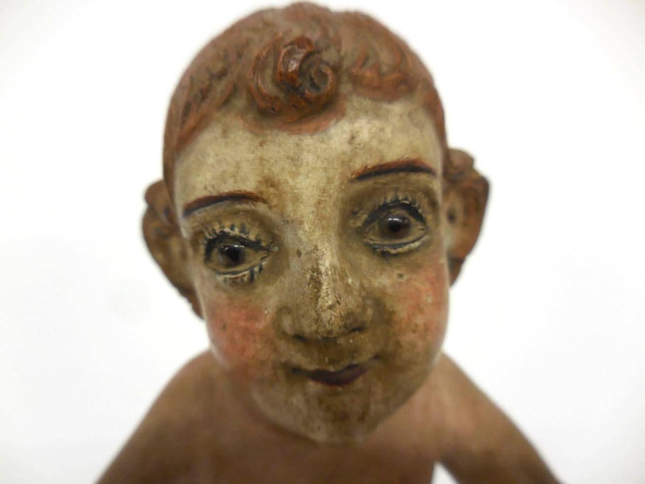 Very sweet boy with red curly hair, rosy cheeks and big eyes. Polychrome on cedro wood. 19th century nino. Two fingers on the left hand are chipped off. Feet are intact. Big ears. Nino itself measures about 6.5